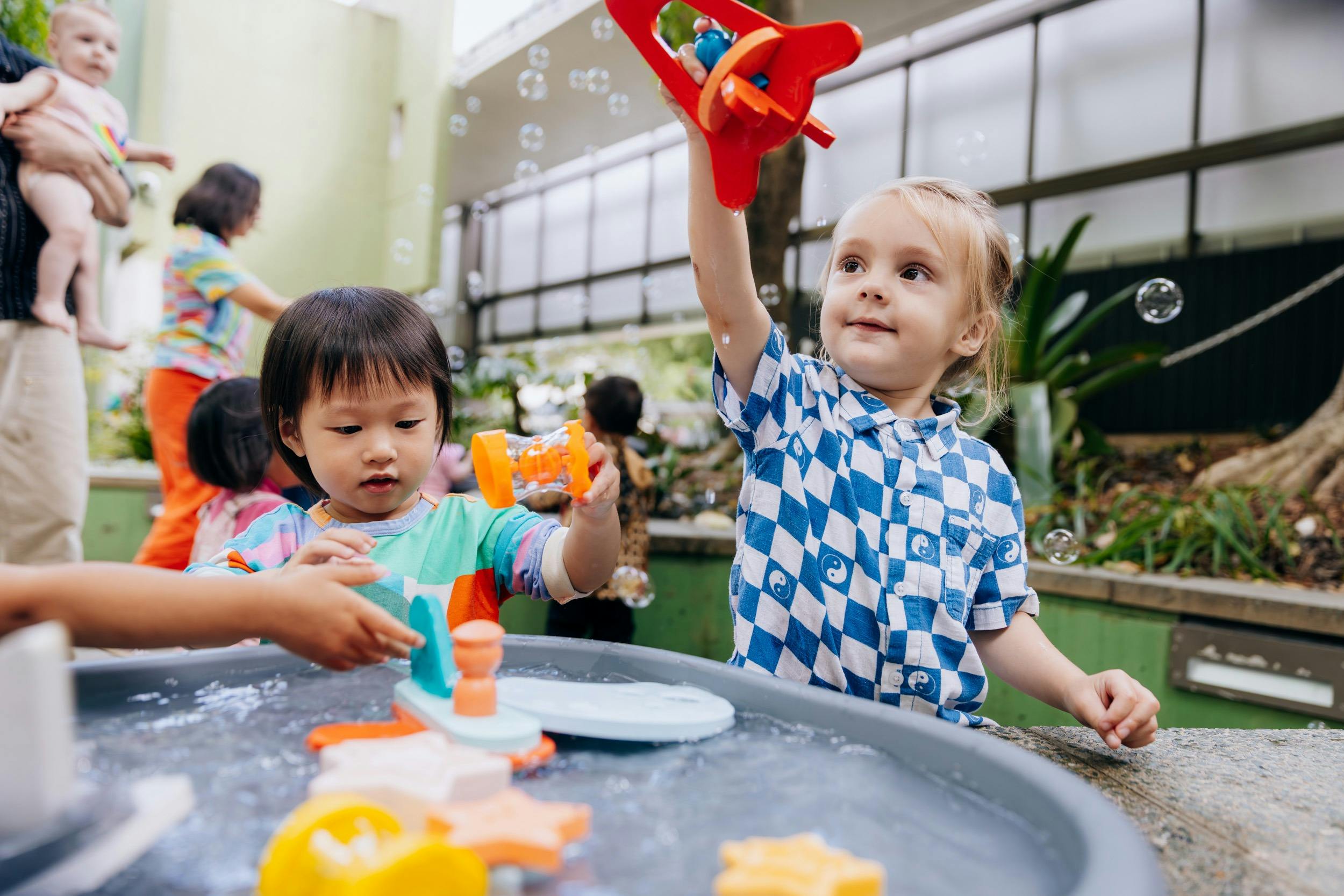 Children enjoy the courtyard at The Corner