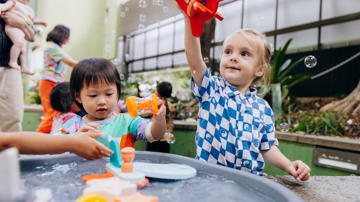 Children enjoy the courtyard at The Corner