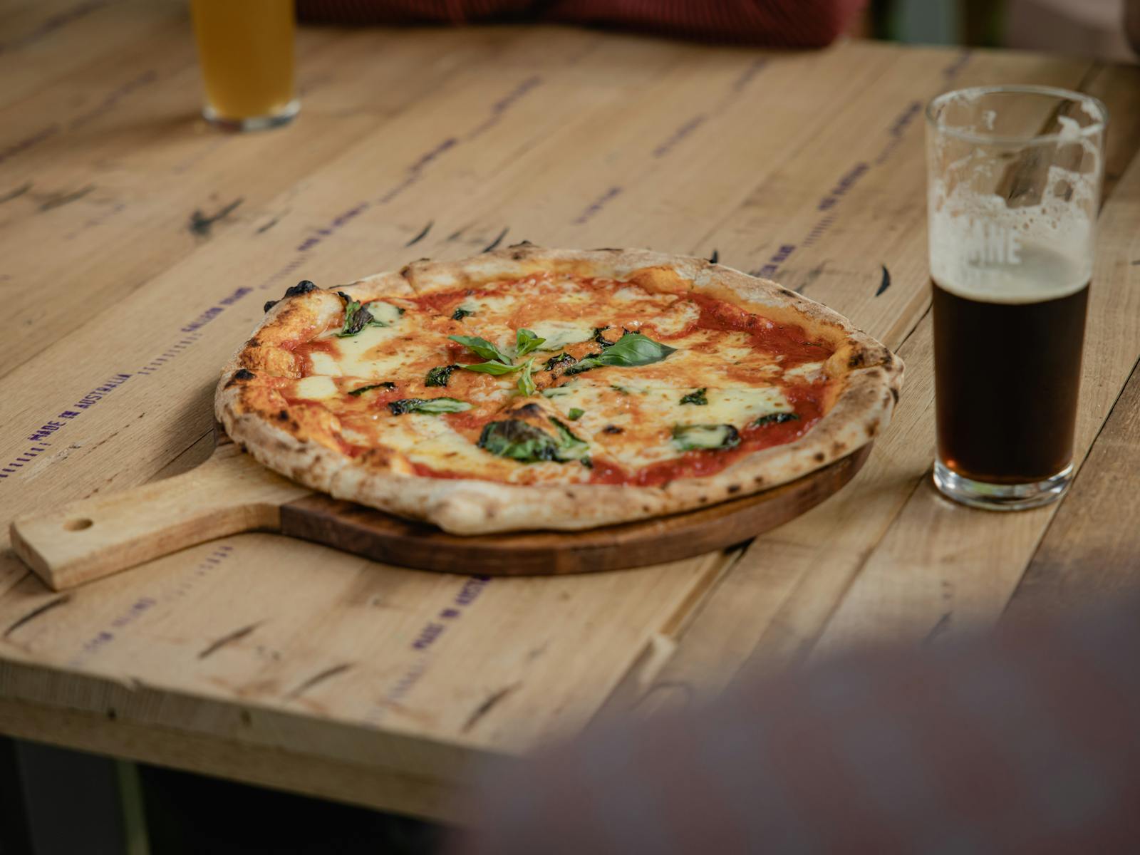 Margarita pizza and a schooner of dark beer