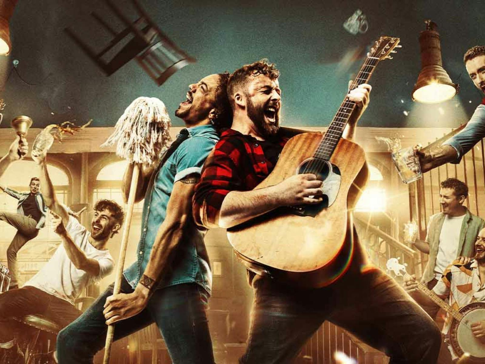 A lively scene in a bar shows two men in the foreground