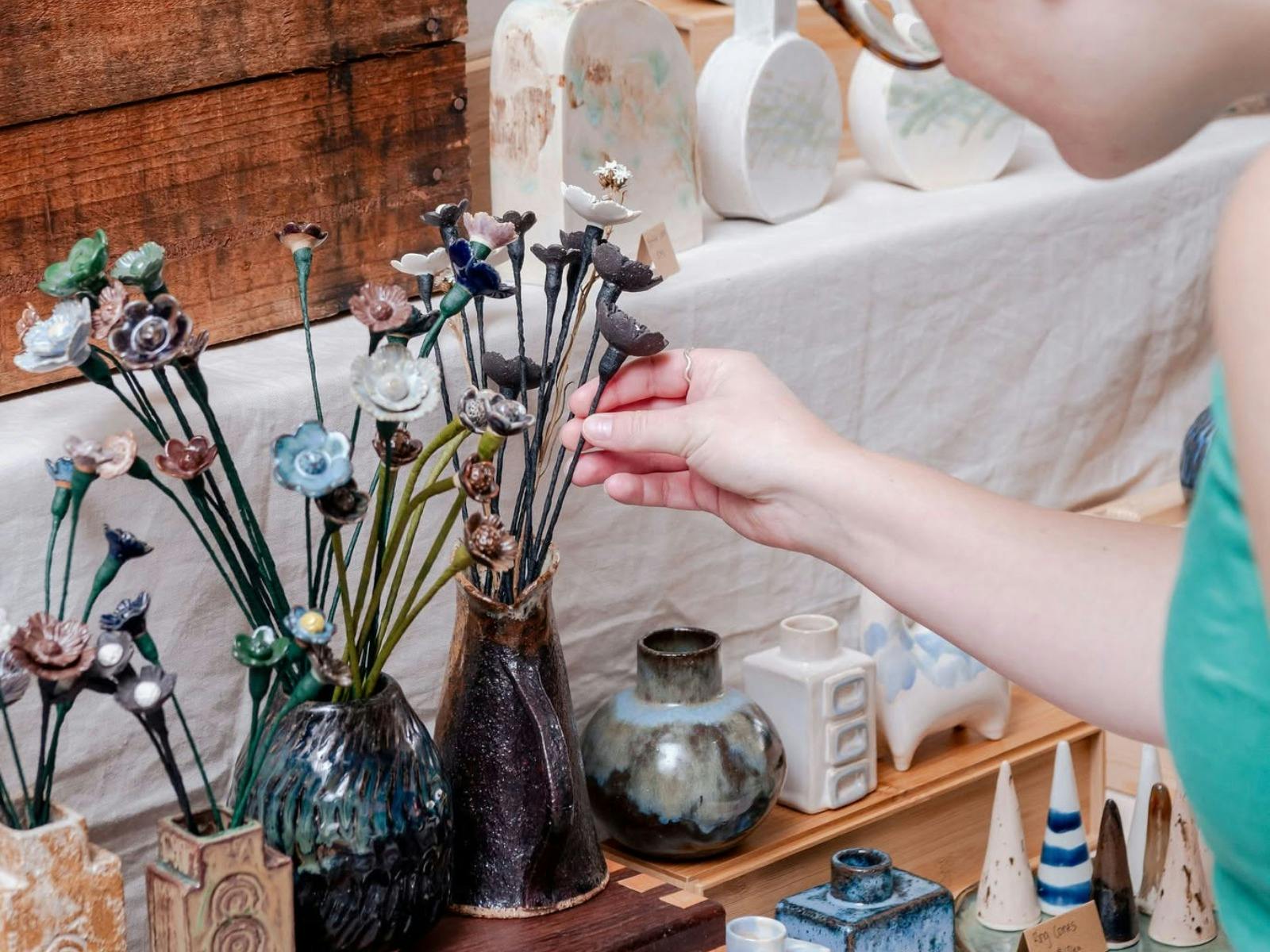 A Hand Feeling some Handmade Ceramic Flowers