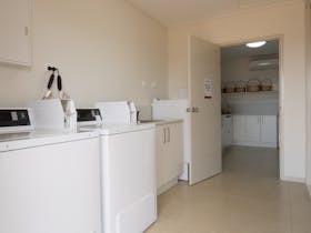 Guest Laundry includes two commercial washing machines and a single drier