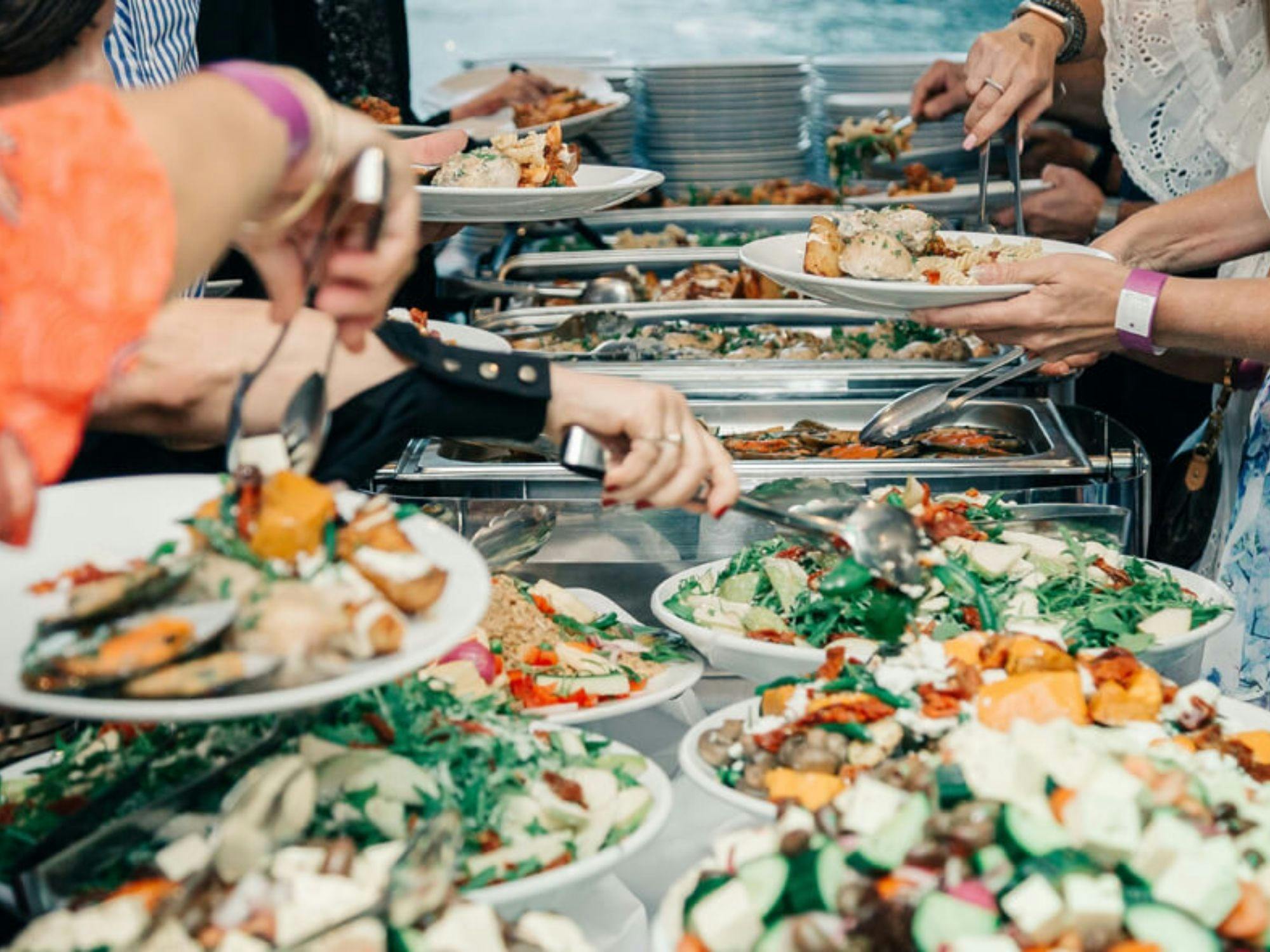 Guests serving themselves from a buffet spread on Aussie Magic during a harbour cruise