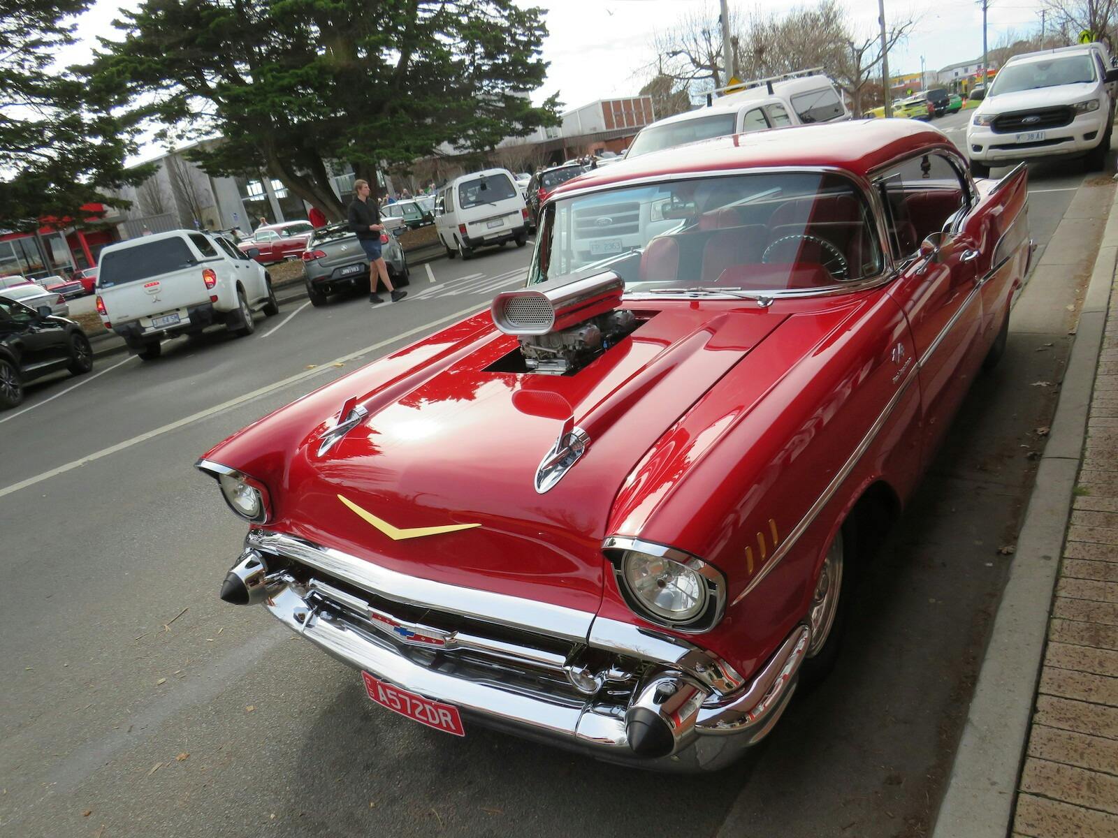 Shiny red Chevy with prominent air scoop