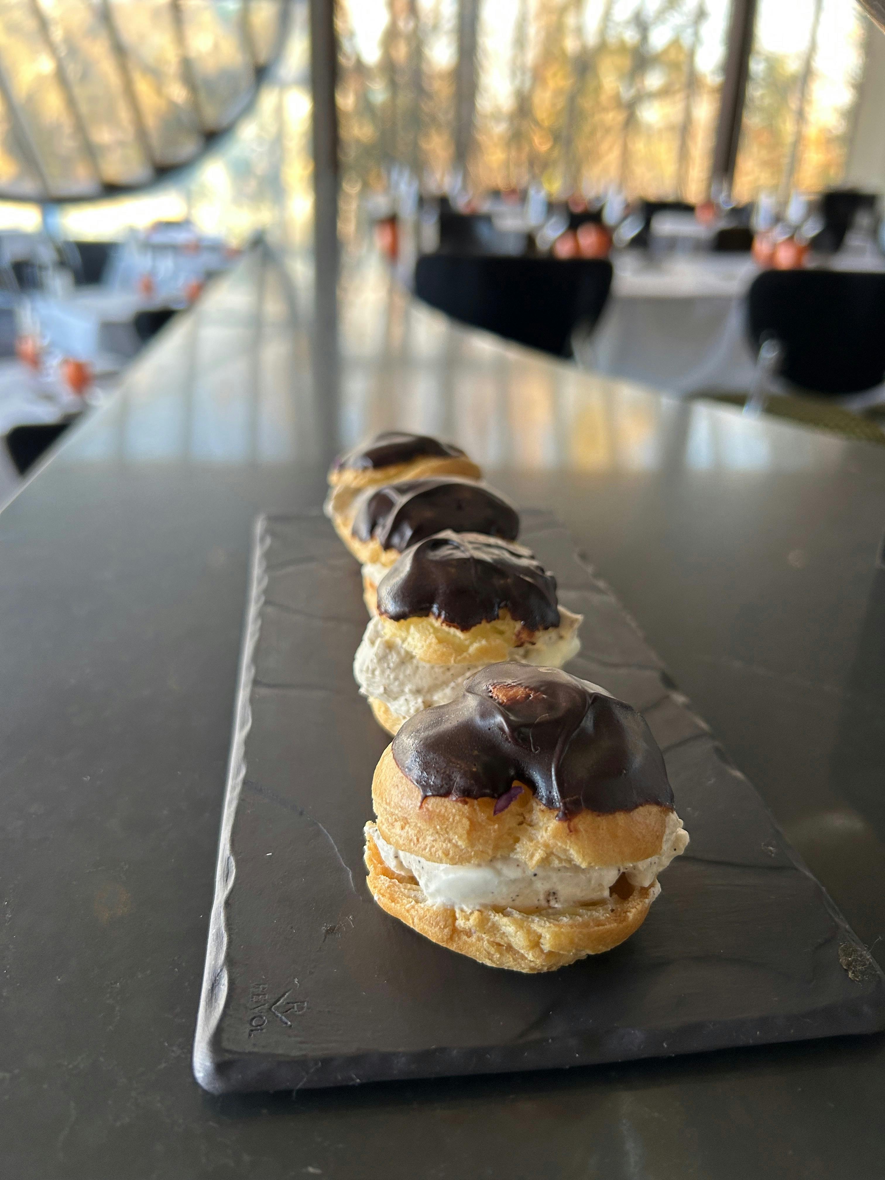 Chocolate dipped choux bun with wattle seed cream
