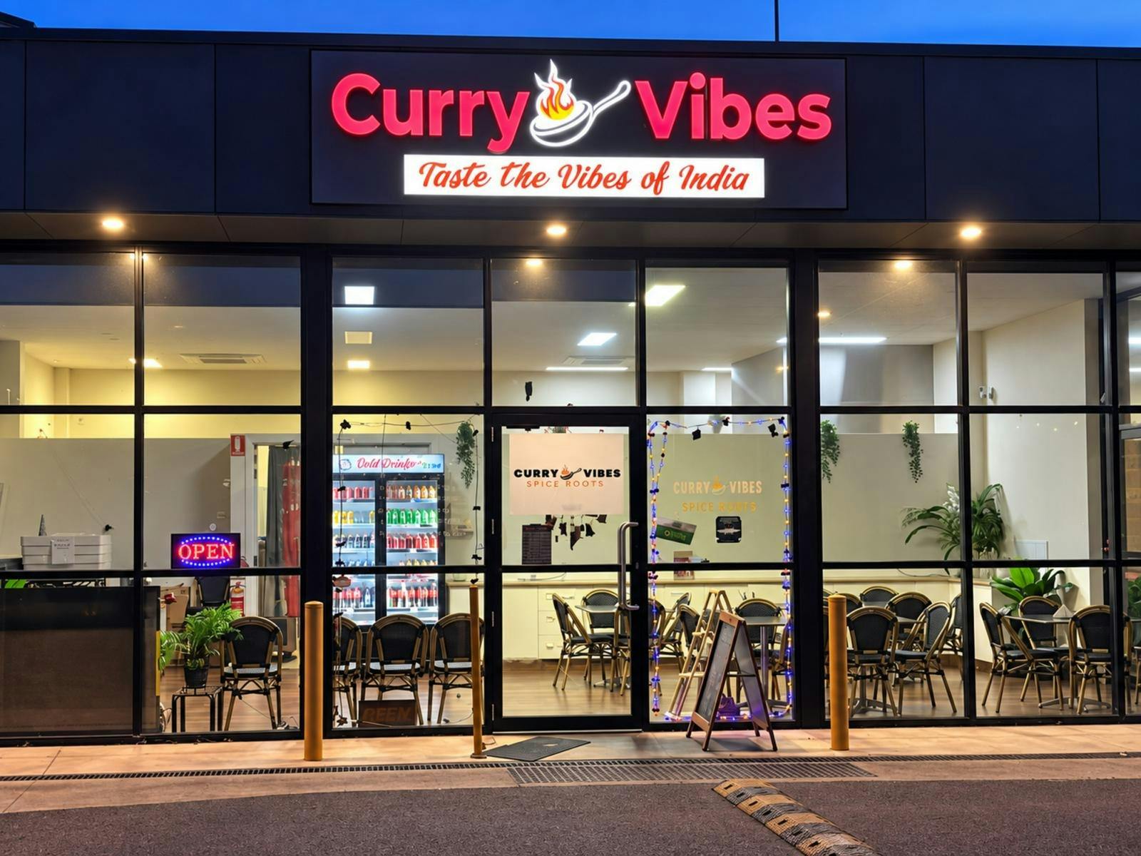 Front entrance of Curry Vibes Indian restaurant at night in Lavington, NSW.