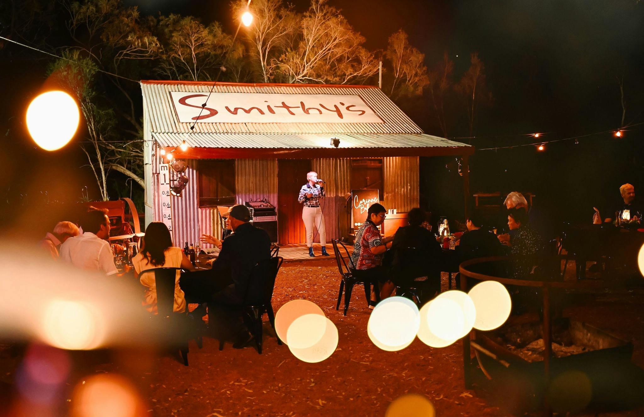 Guests enjoy camp oven cuisine while being serenaded under the stars in Longreach.