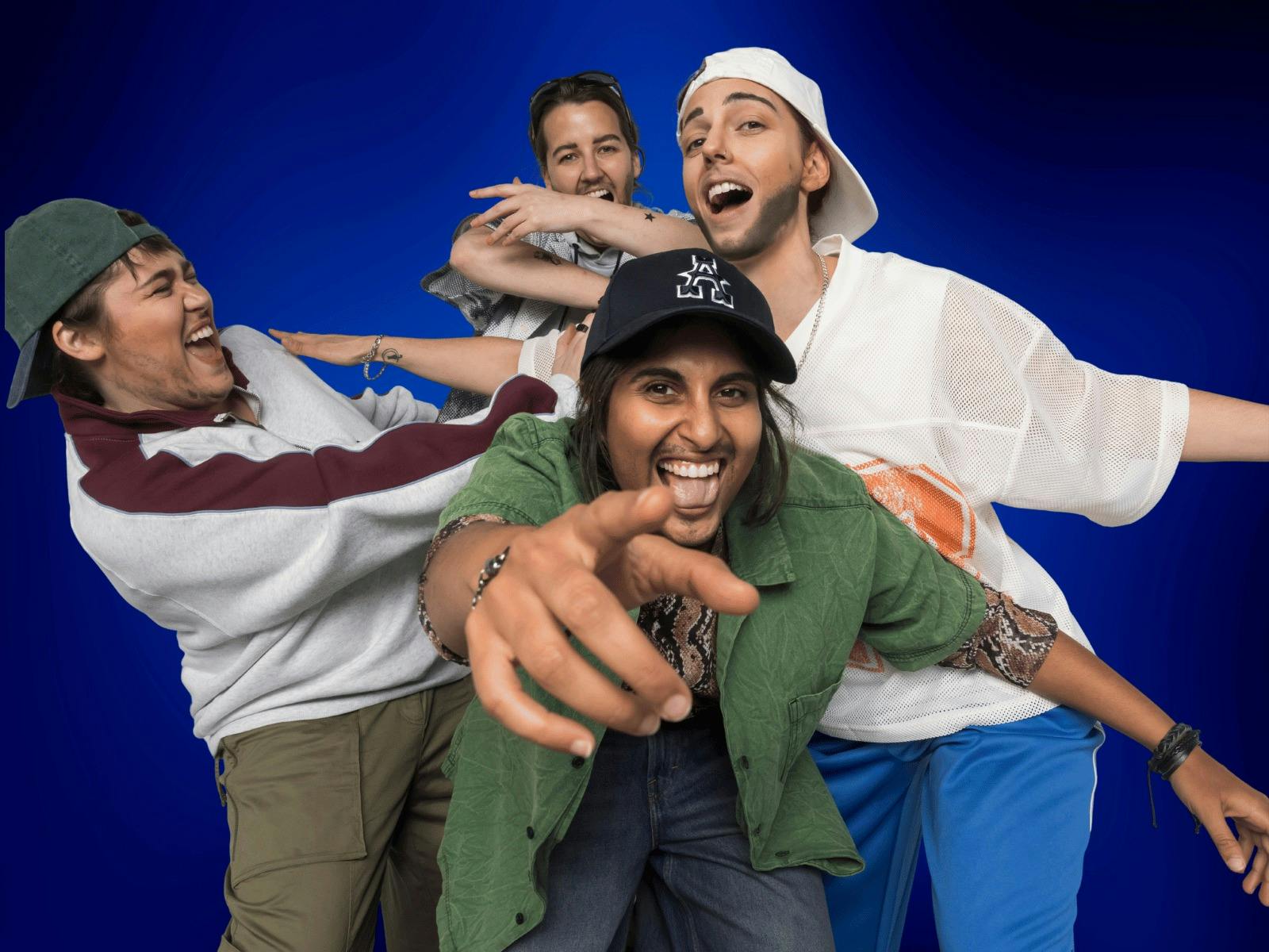 Four Drag Kings dressed as boy band members