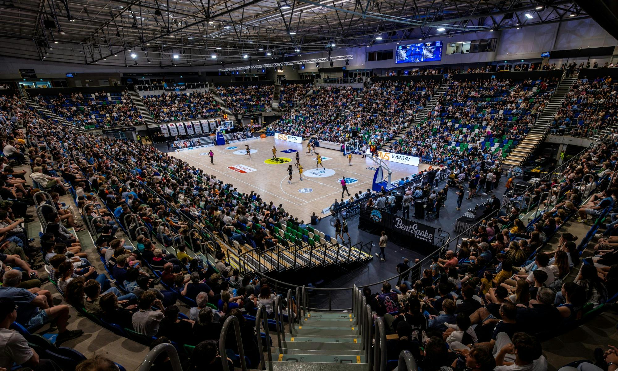 A full arena watching a UC Capitals game from the stands.