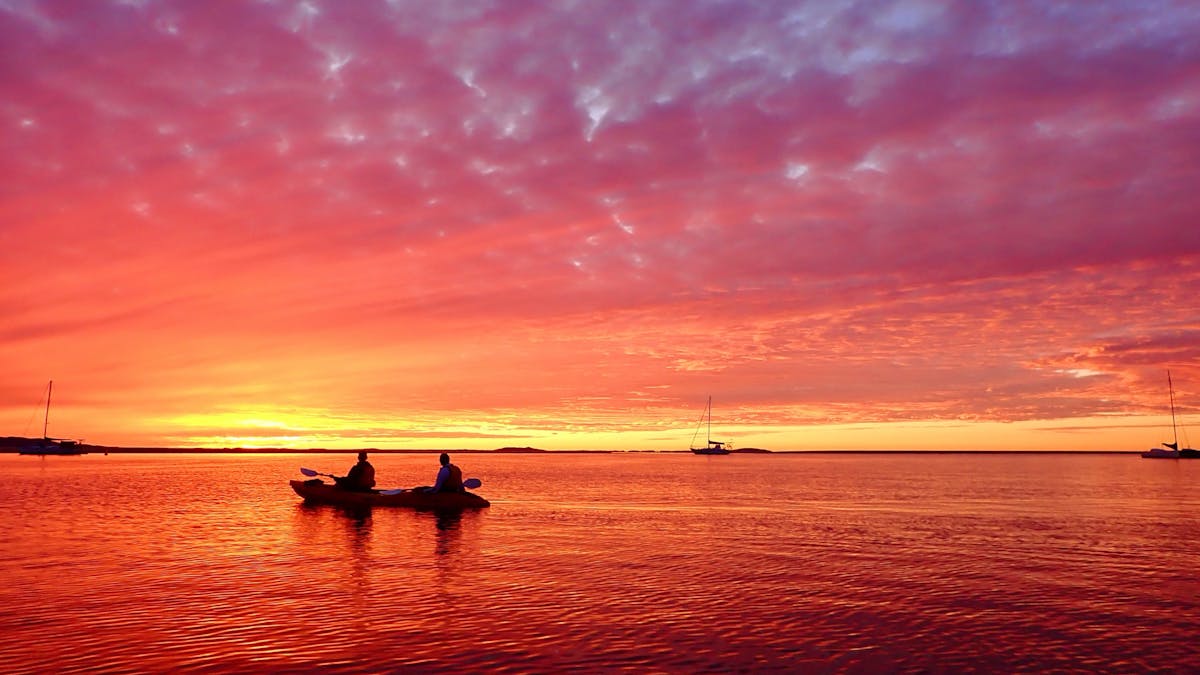 Enjoy a spectacular ocean sunset from a kayak with 1770 Liquid Adventures