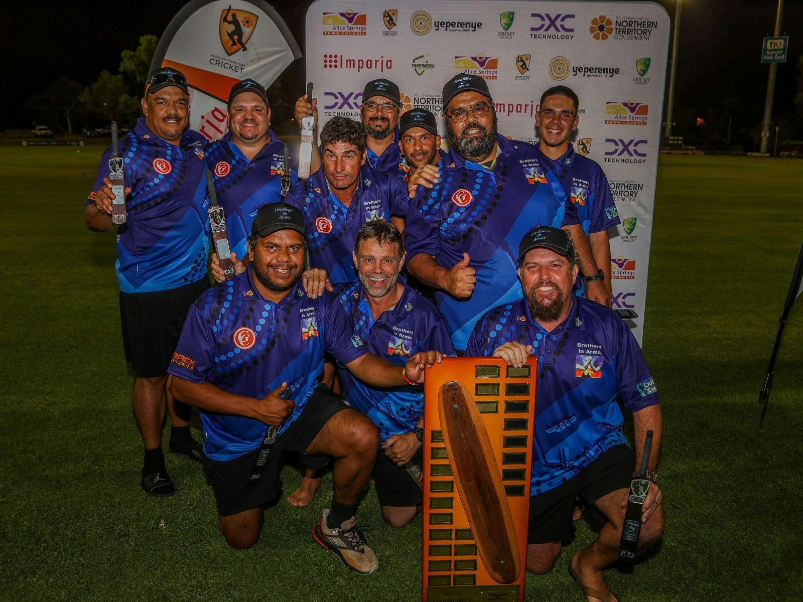 Group of men celebrating winning a cricket competition