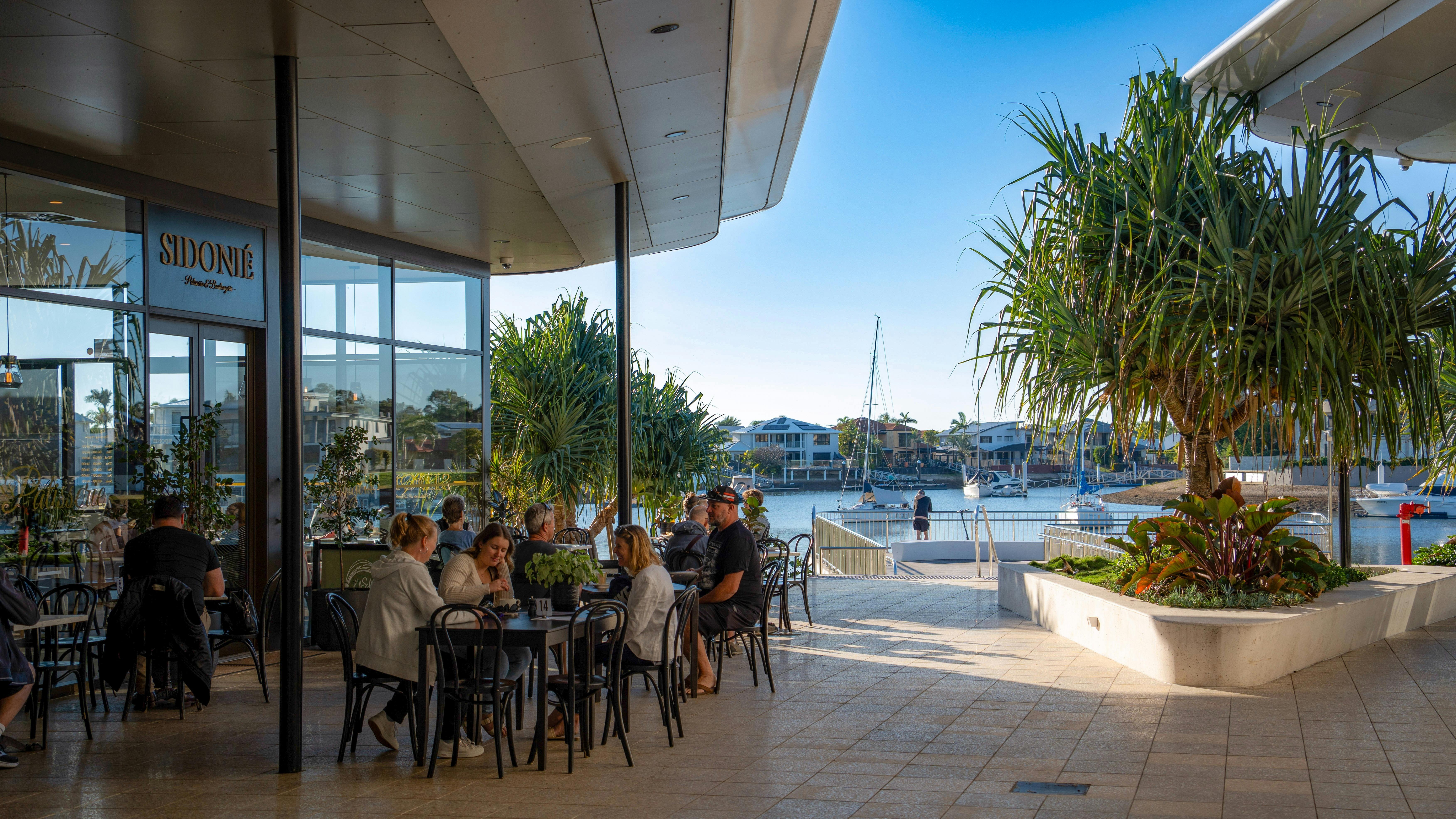 Guests seated at outdoor café tables overlooking the Newport waterfront.