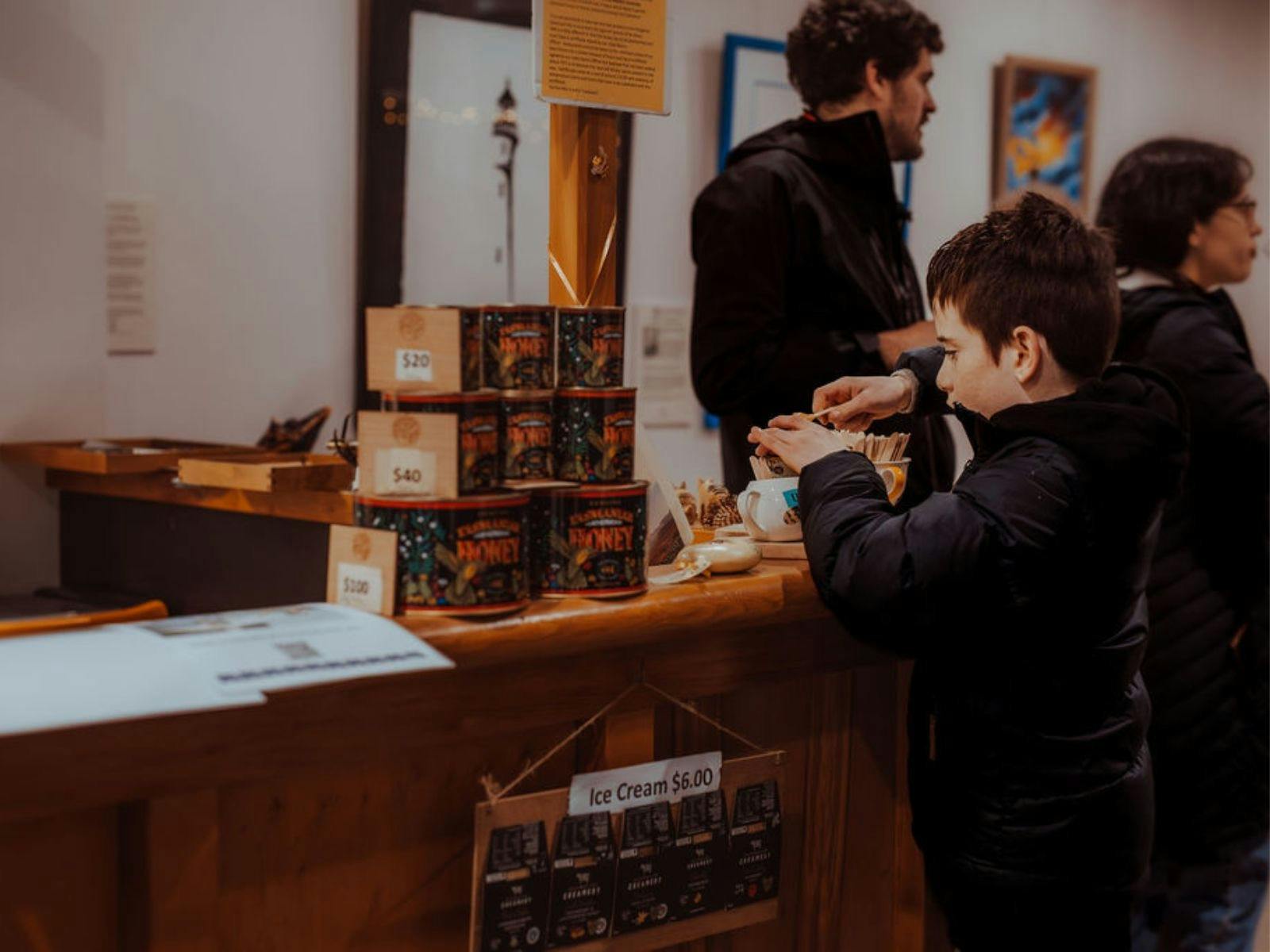 Child sampling honey at the Huon Pine Shop.
