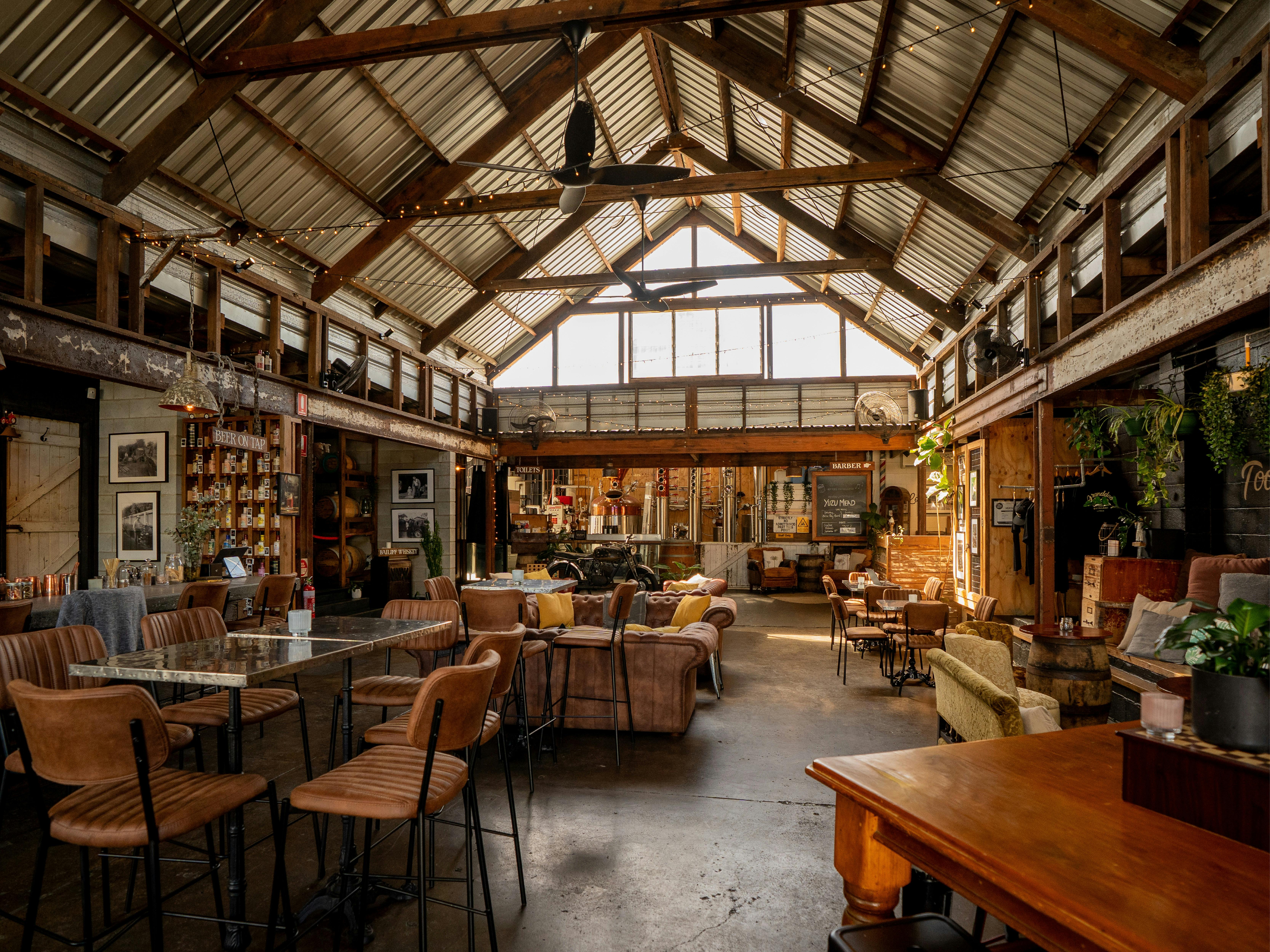 Exposed timber beams, industrial features, and relaxed seating before service begins.