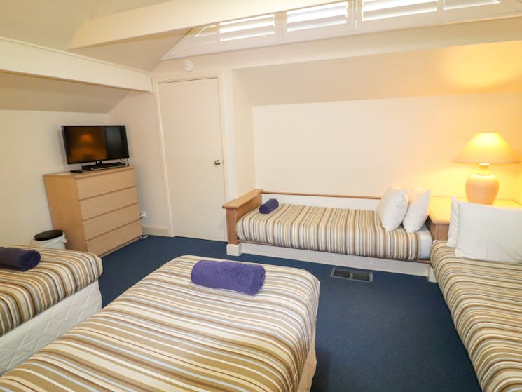 The loft/ third bedroom has 4 single beds and a second TV