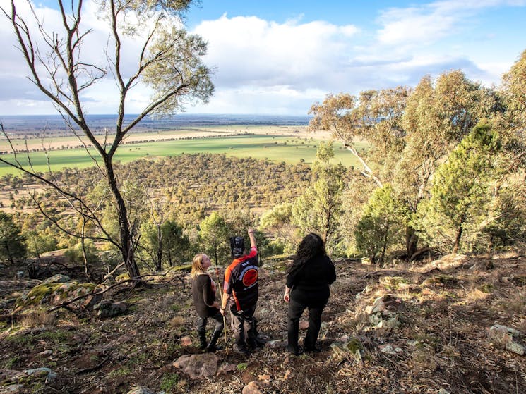 Bundyi Aboriginal Cultural Tours guide Mark Saddler  with tourists at Galore Hill Lockout