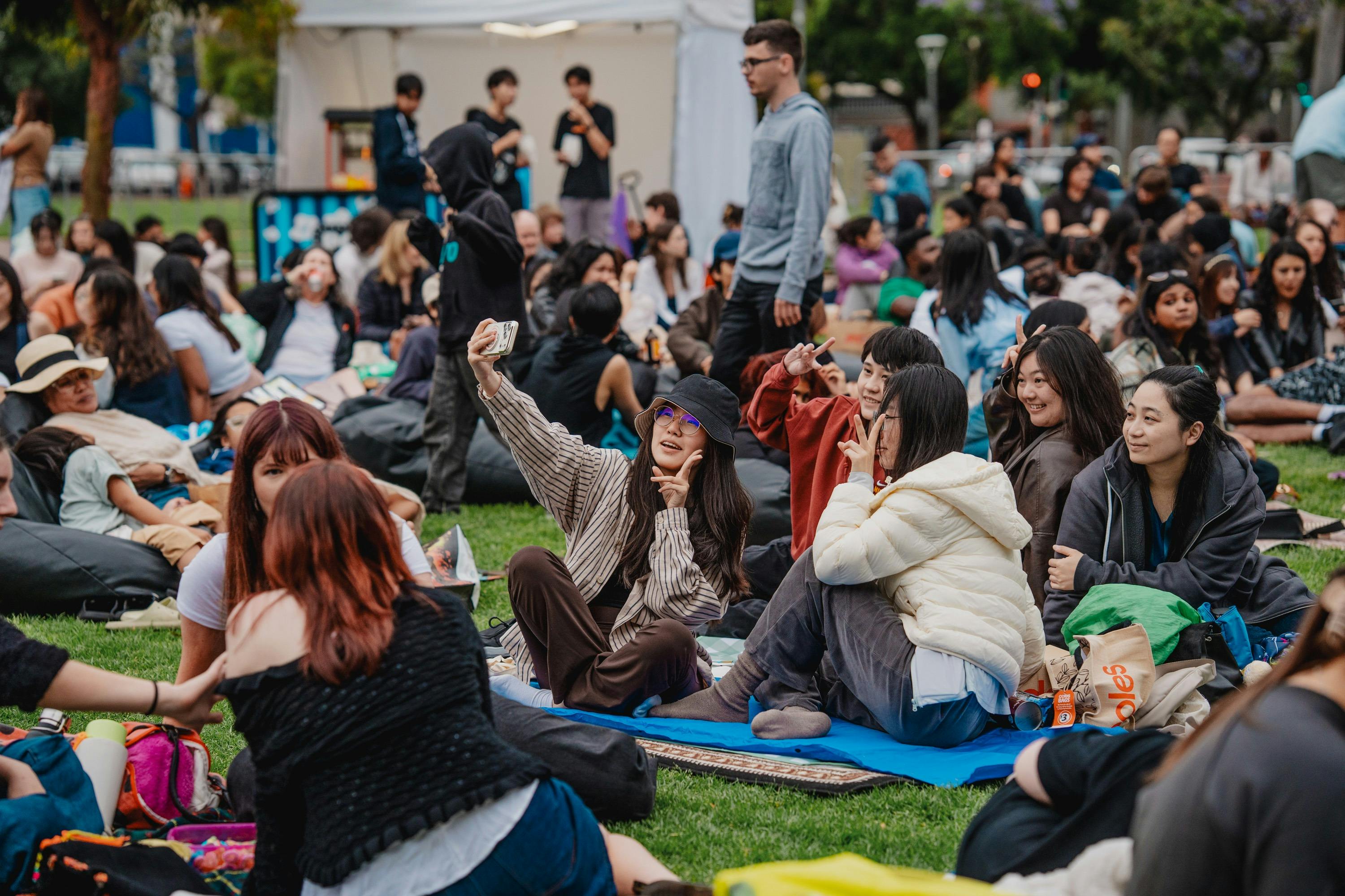 Friends at outdoor event taking selfie