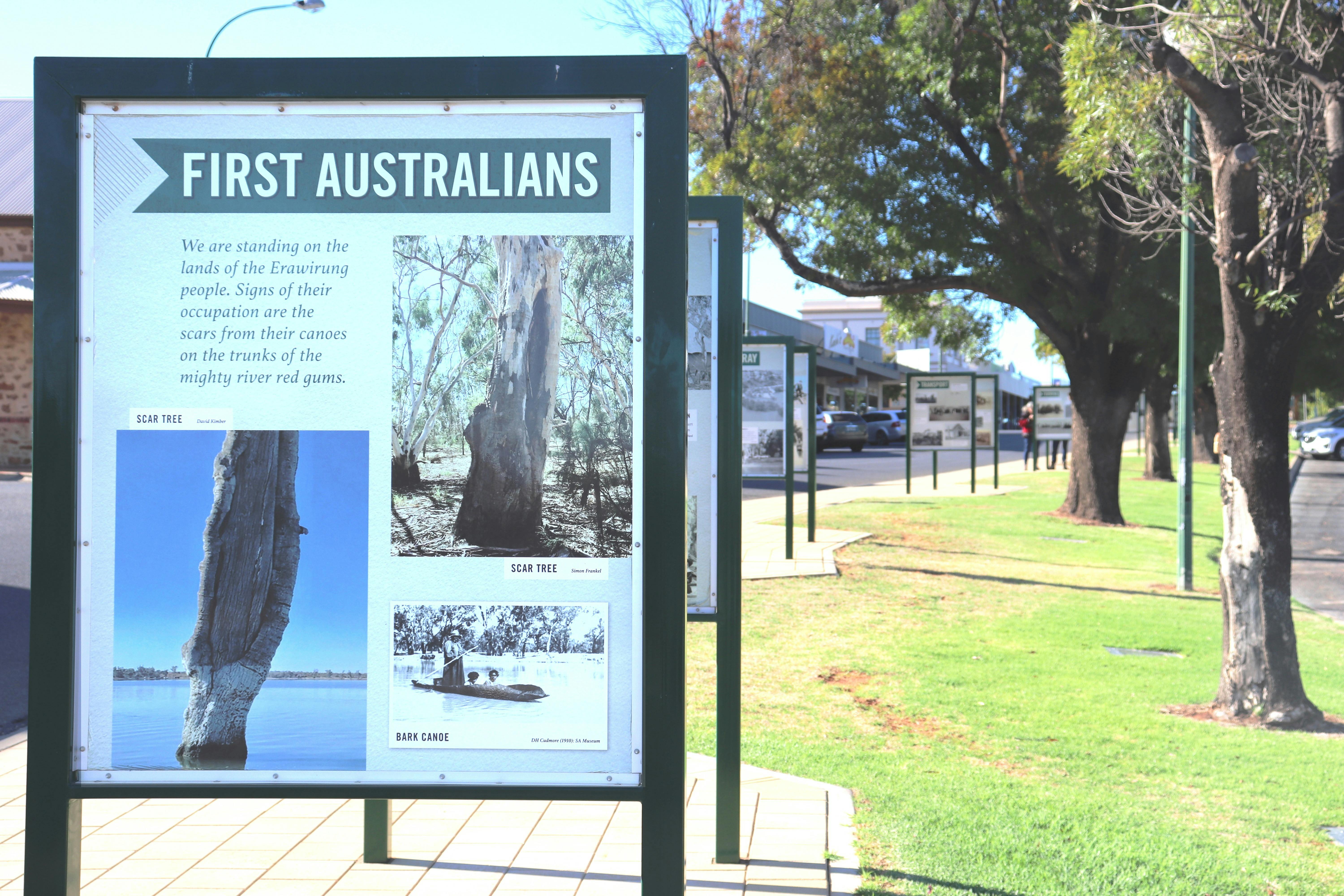 Twenty-seven large double-sided boards line a paved walkway in the middle of the town's main street.