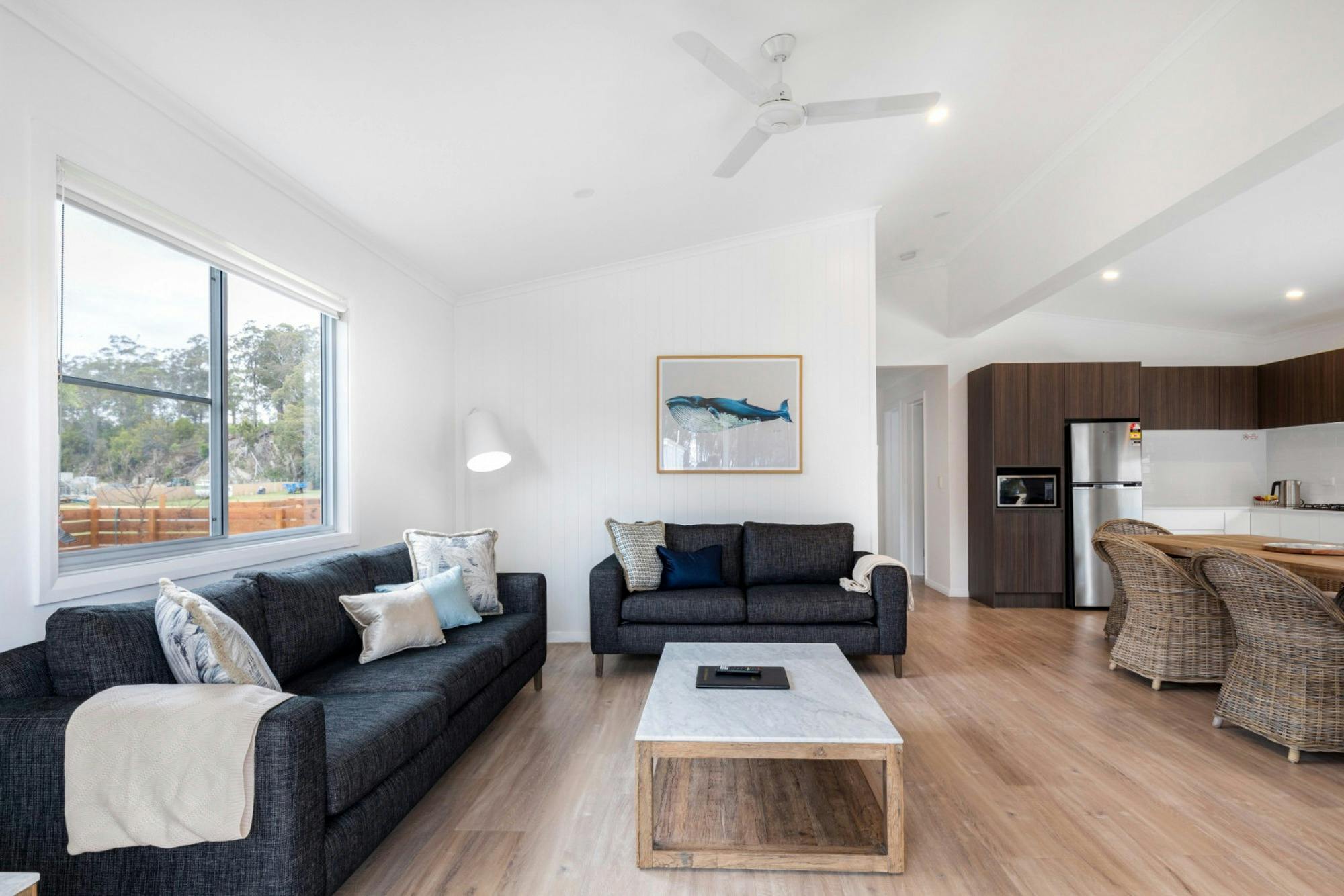 A bright, open-plan villa living and dining area at Seahorse Inn in Boydtown, featuring modern charc