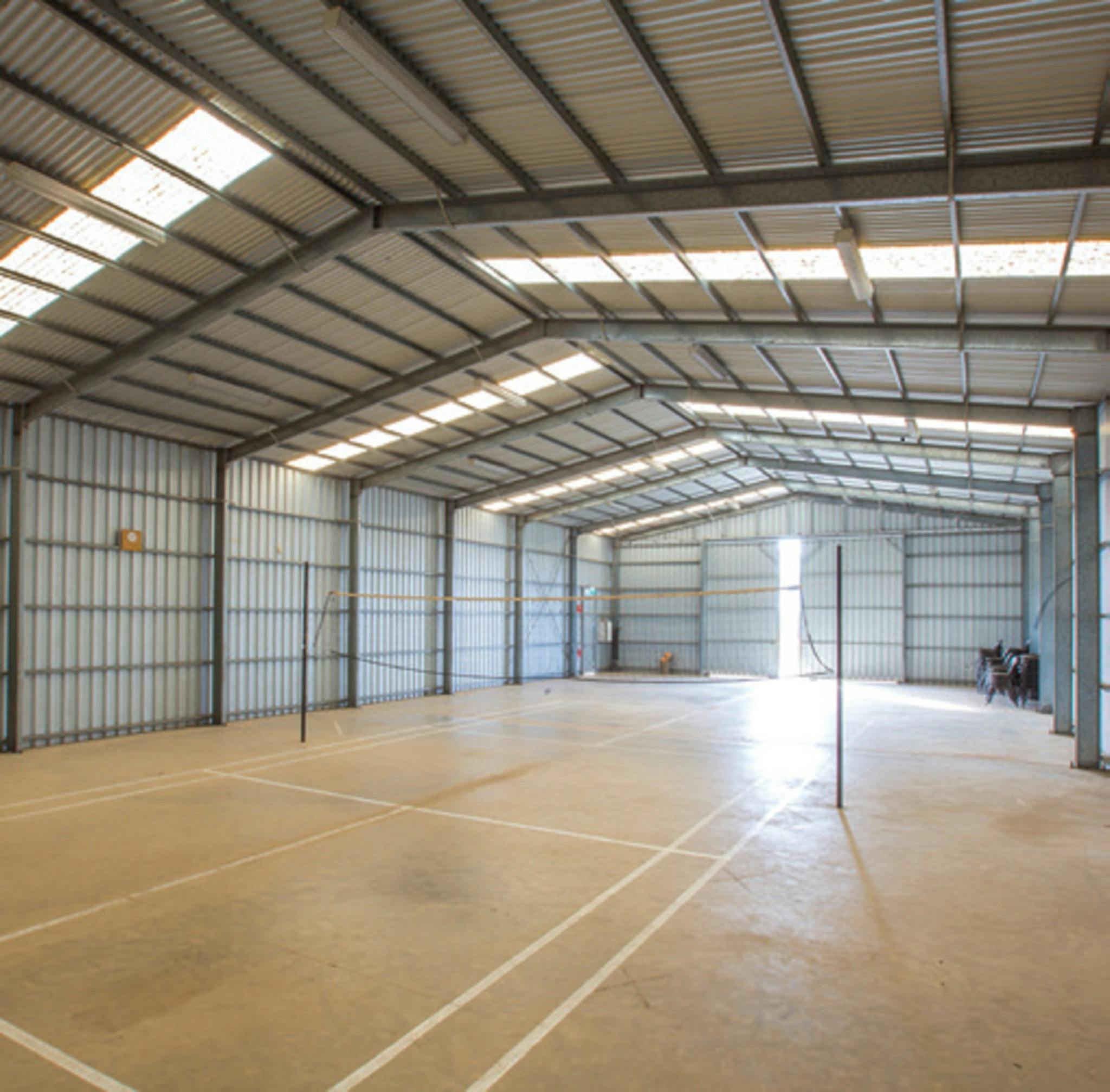 Indoor Sports and Activities Unit Featuring badminton court, ideal assembly and games area.