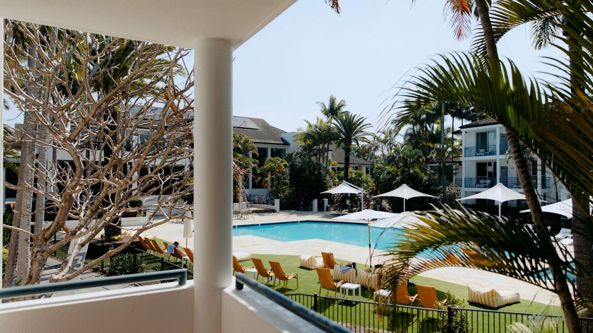View from balcony of hotel room overlooking the pool