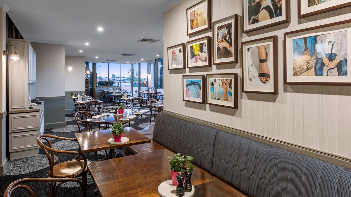 Restaurant with tables and pictures on the wall