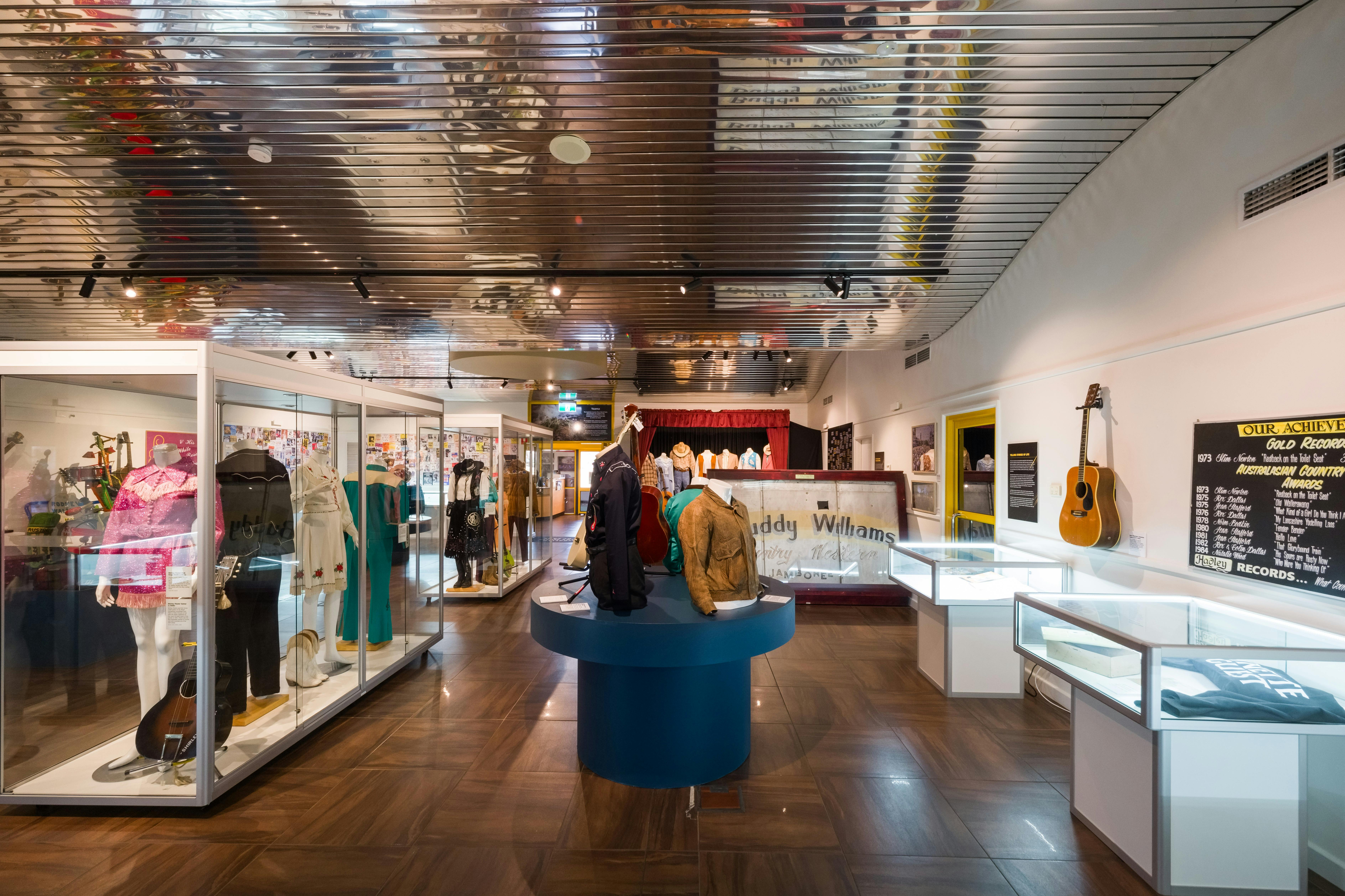 Depicts a landscape photograph of inside the Australian Country Music Hall of Fame exhibition