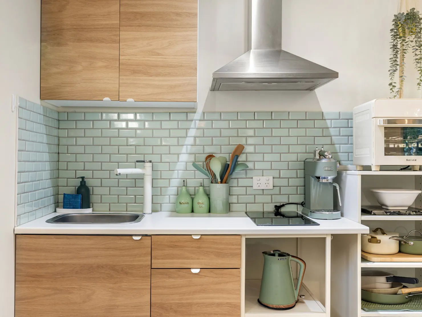 Modern Kitchenette with induction stove, coffee machine and refrigerator