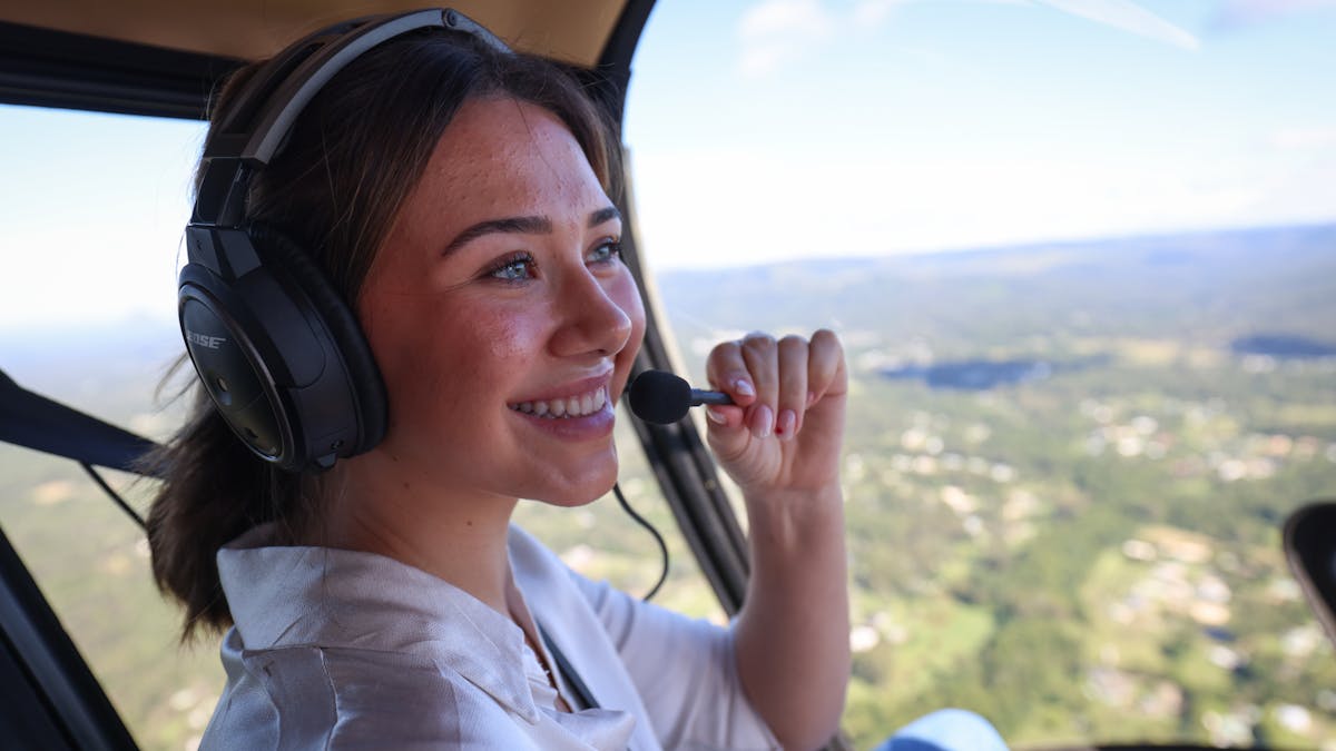 A passenger enjoying a flight across the Sunshine Coast