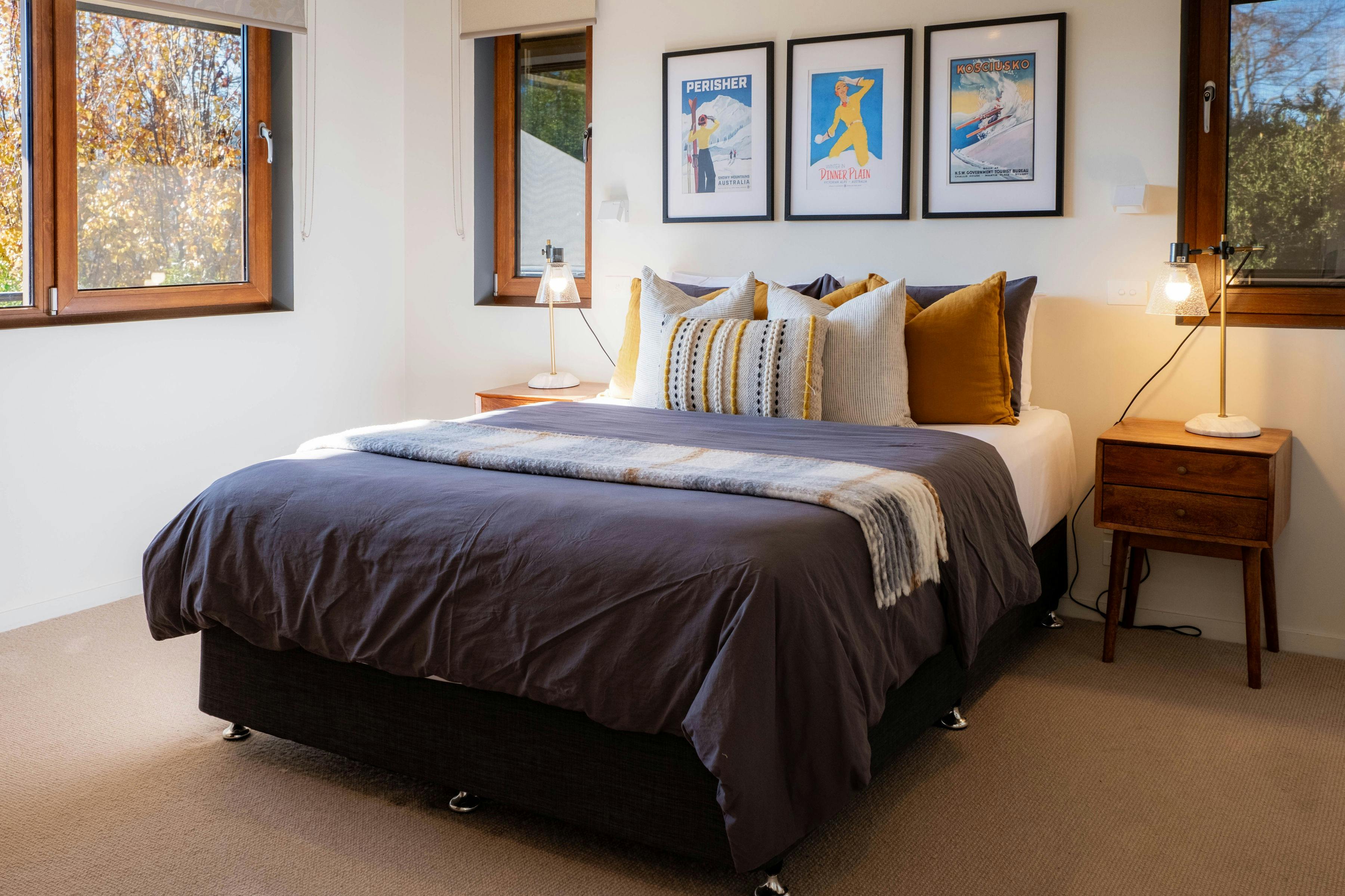 bed, bedside table, lamps and photoframes on the wall in the bedroom at 25 walkers lane