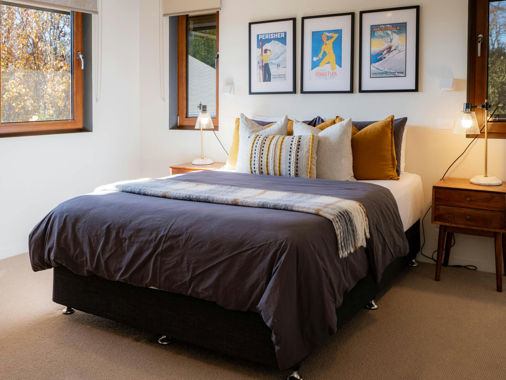 bed, bedside table, lamps and photoframes on the wall in the bedroom at 25 walkers lane
