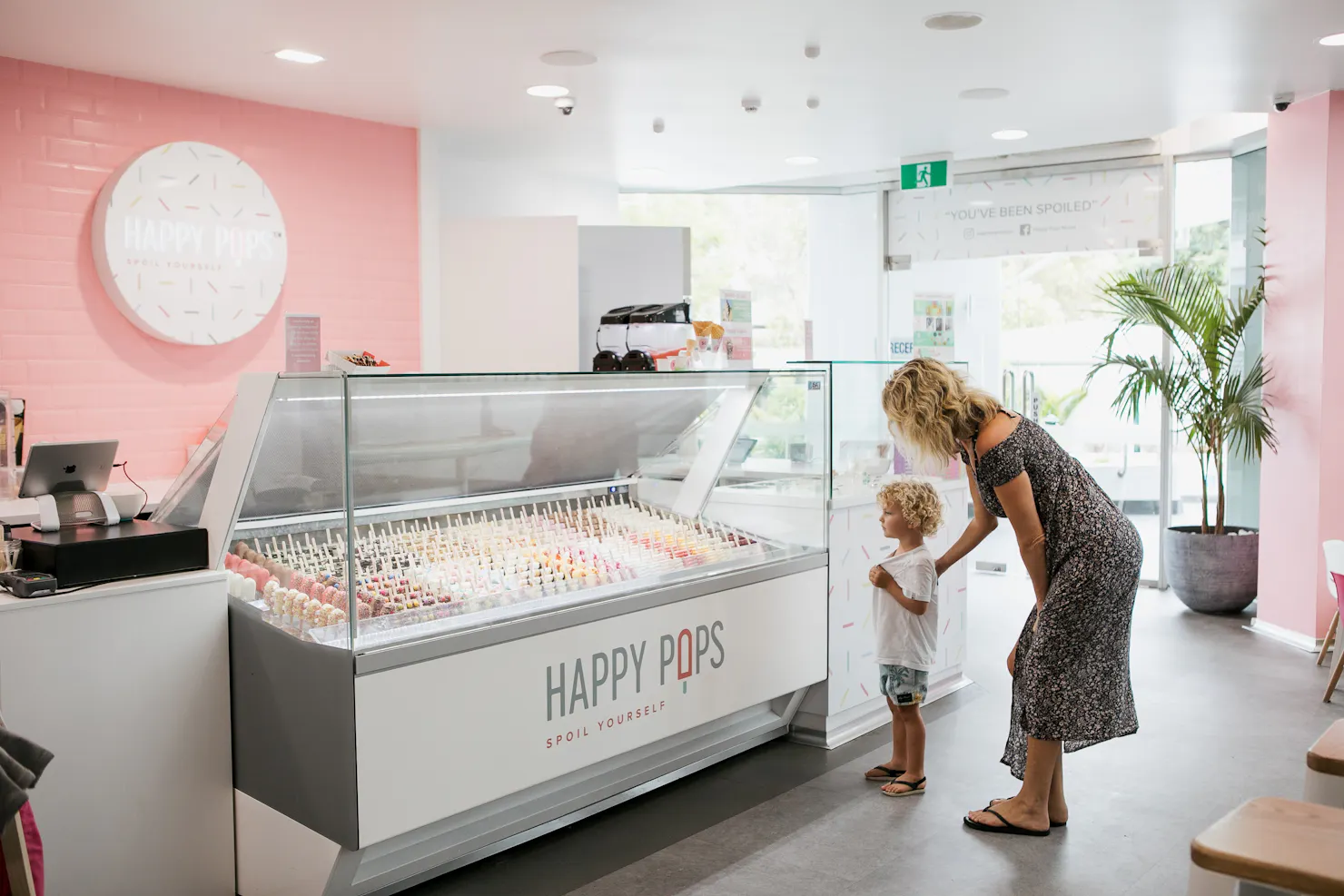 A photo taken inside the Happy Pops store with customers ordering