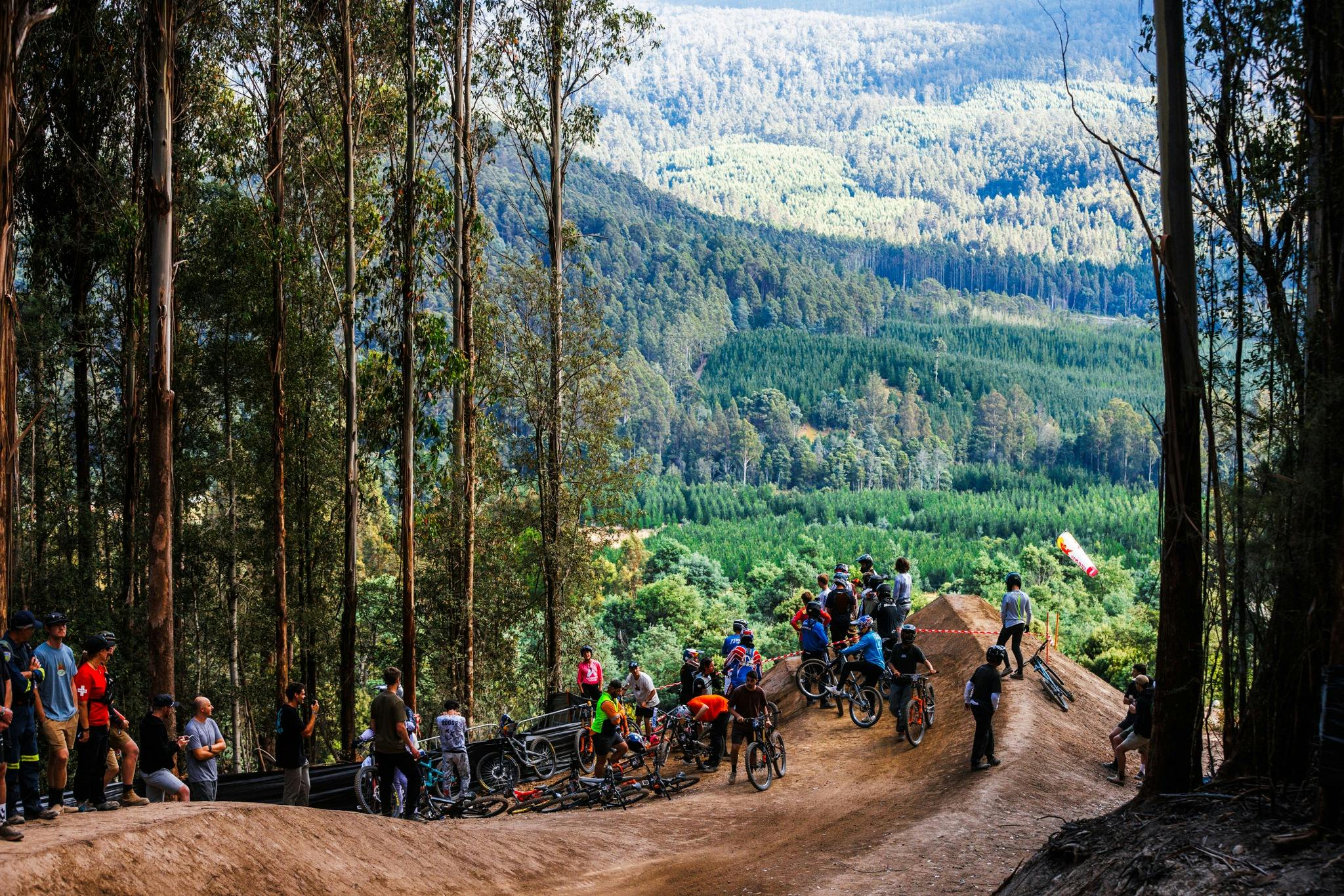 Spectators viewing large mountain bike gap jump