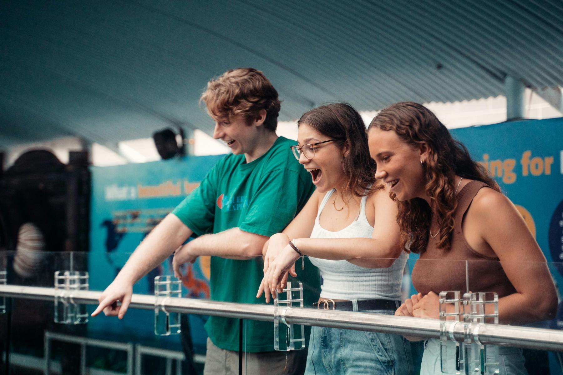 Teenagers pointing and smiling