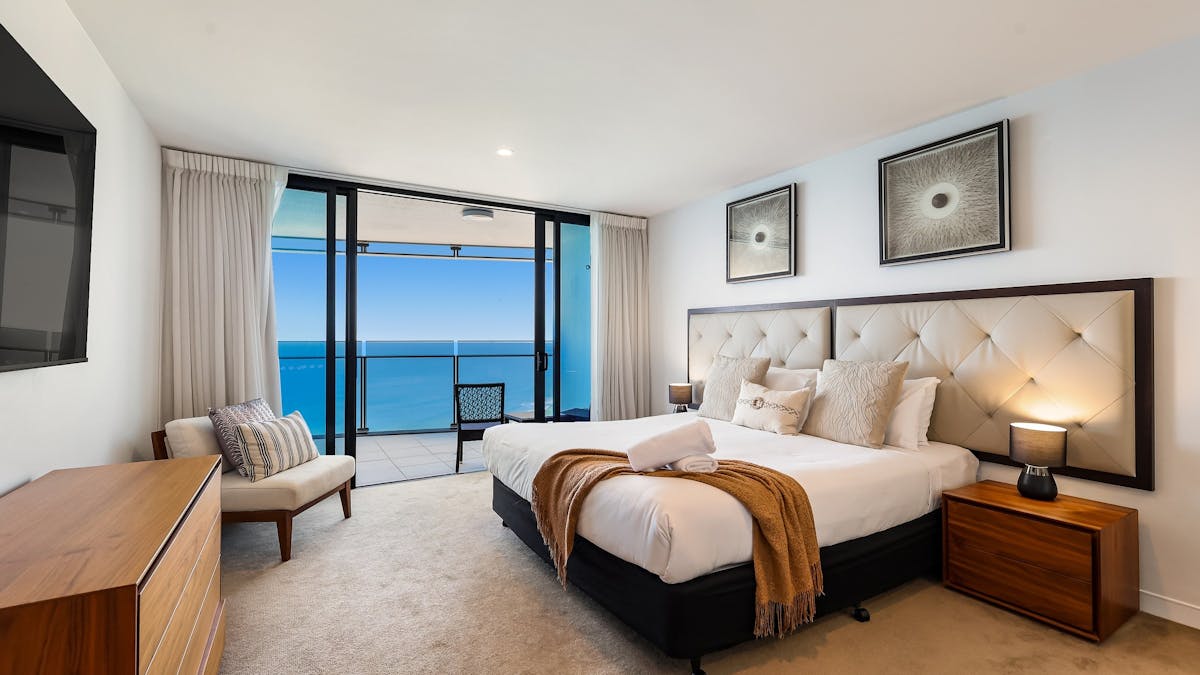 Second bedroom with King bed, balcony access with ocean view, ensuite with bath tub, granite finish