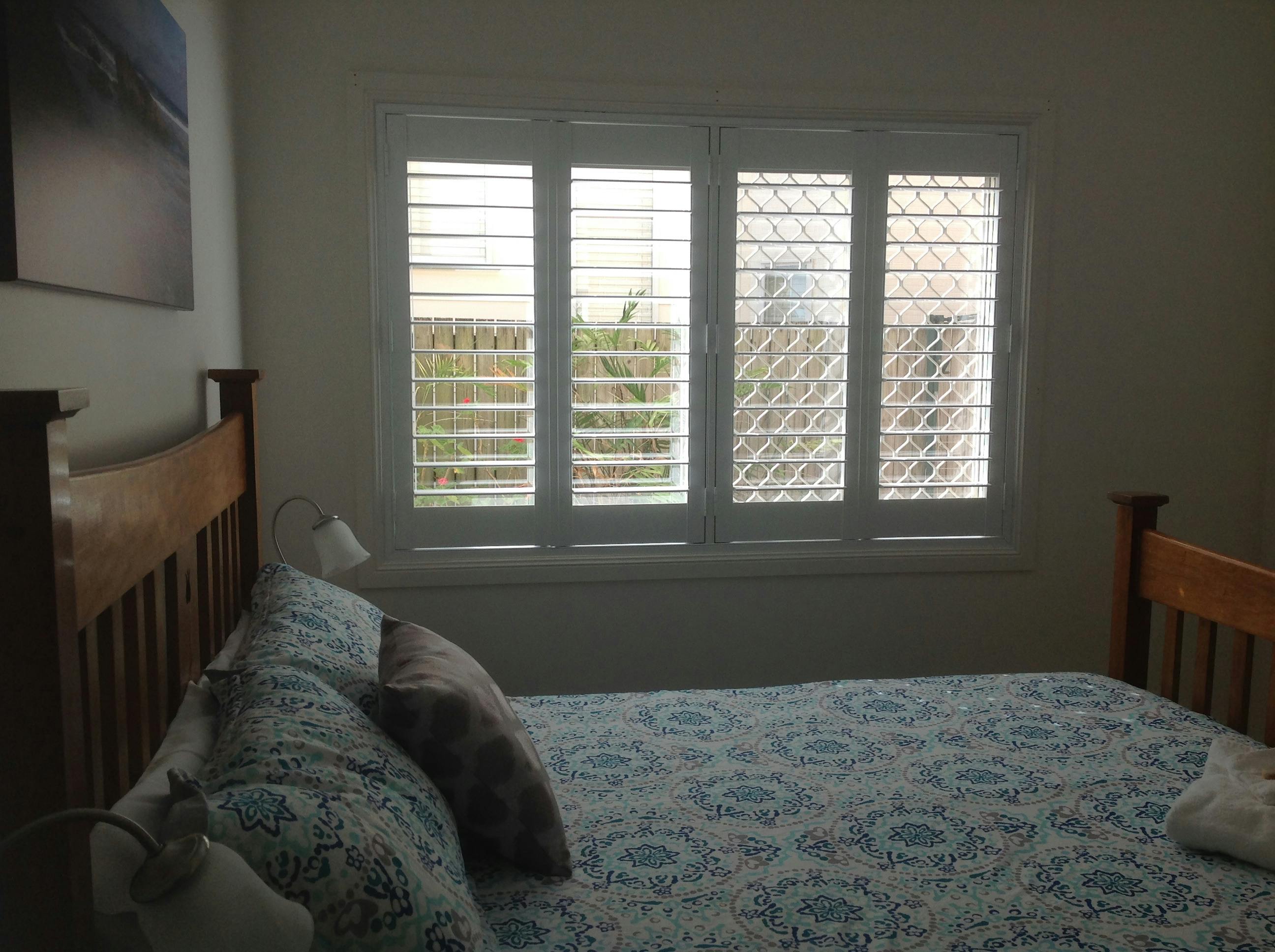 plantation shutters are on the window