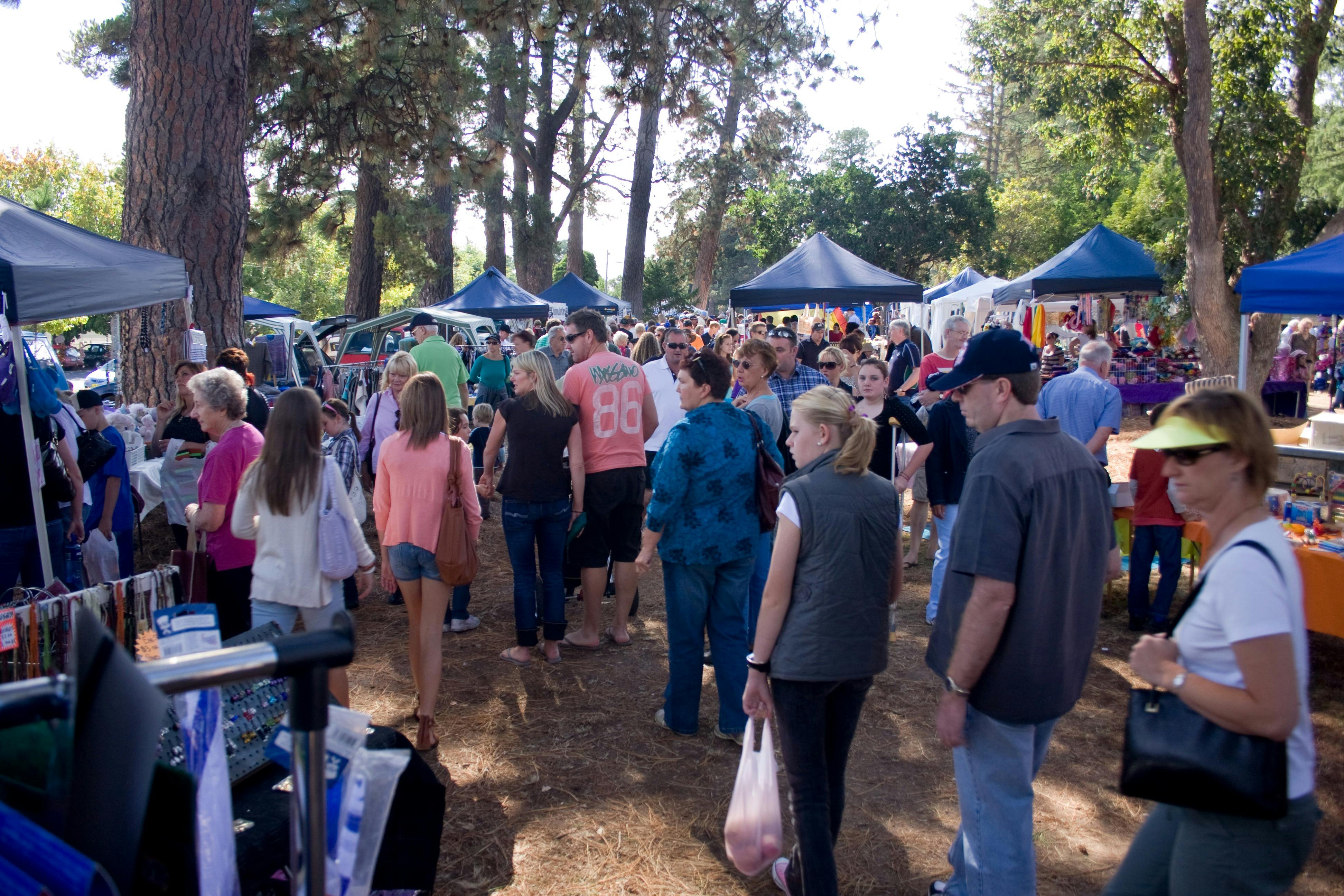 busy rotary market with many visitors browsing the marque stalls