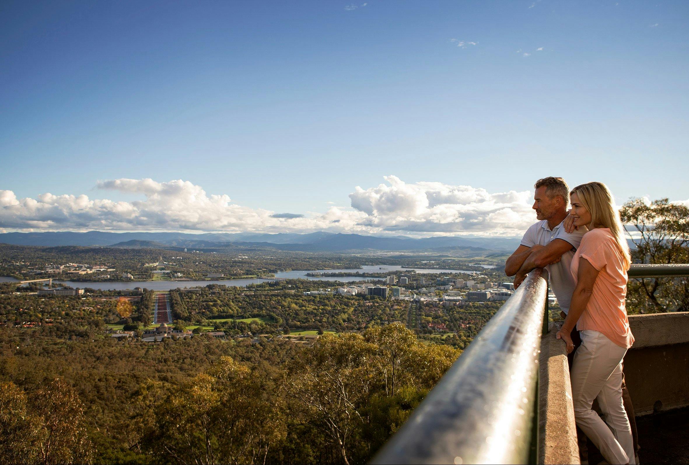 Couple looking out over Canberra from the lookout