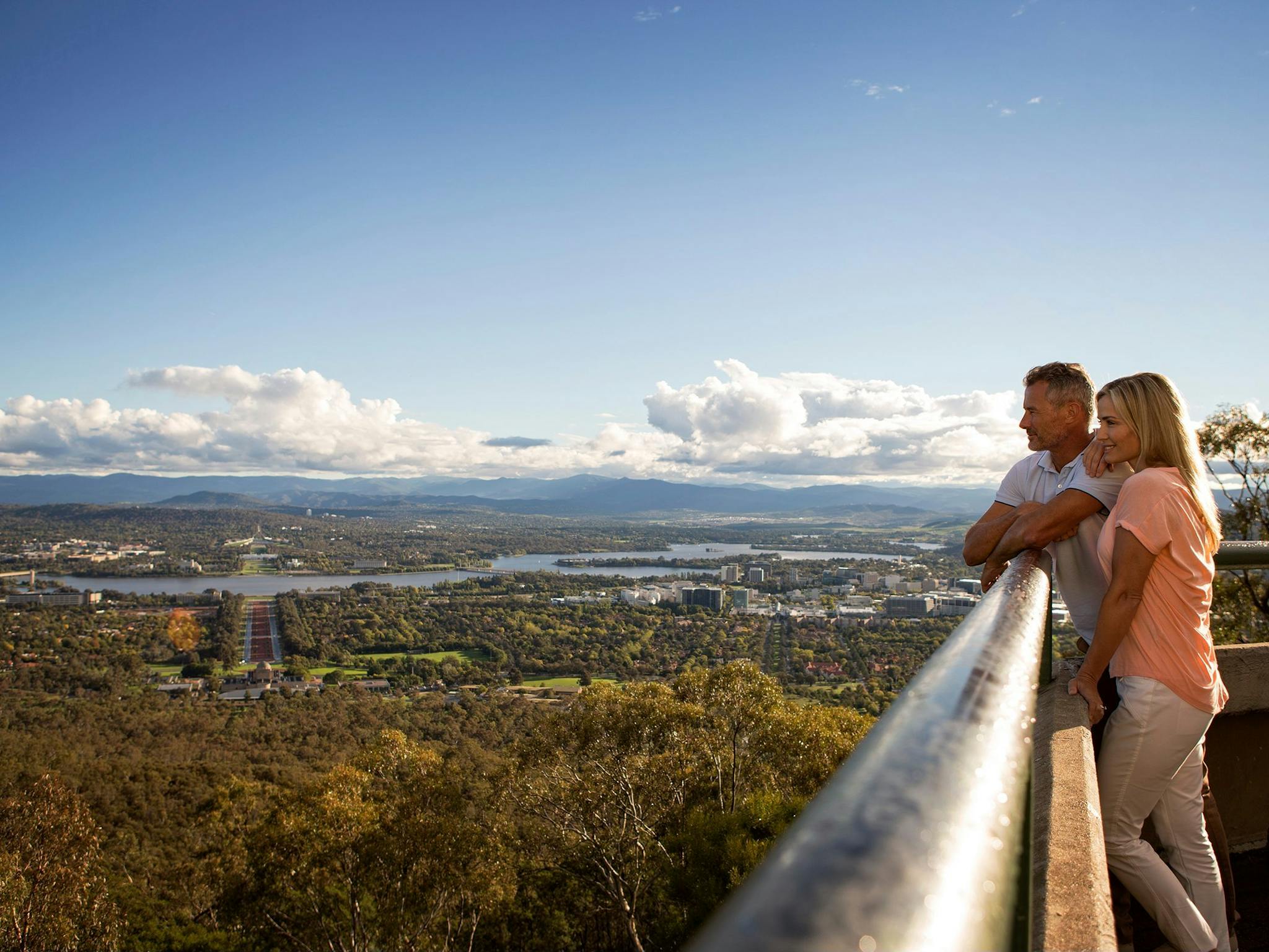 Couple looking out over Canberra from the lookout