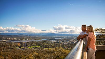 Couple looking out over Canberra from the lookout