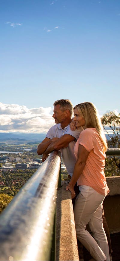 Couple looking out over Canberra from the lookout