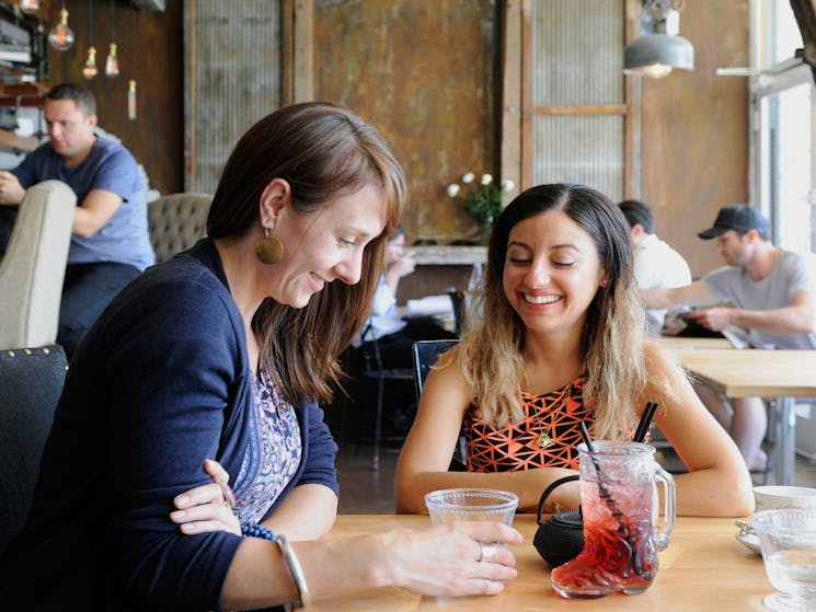 Two girls enjoying a drink at Henri Marcs