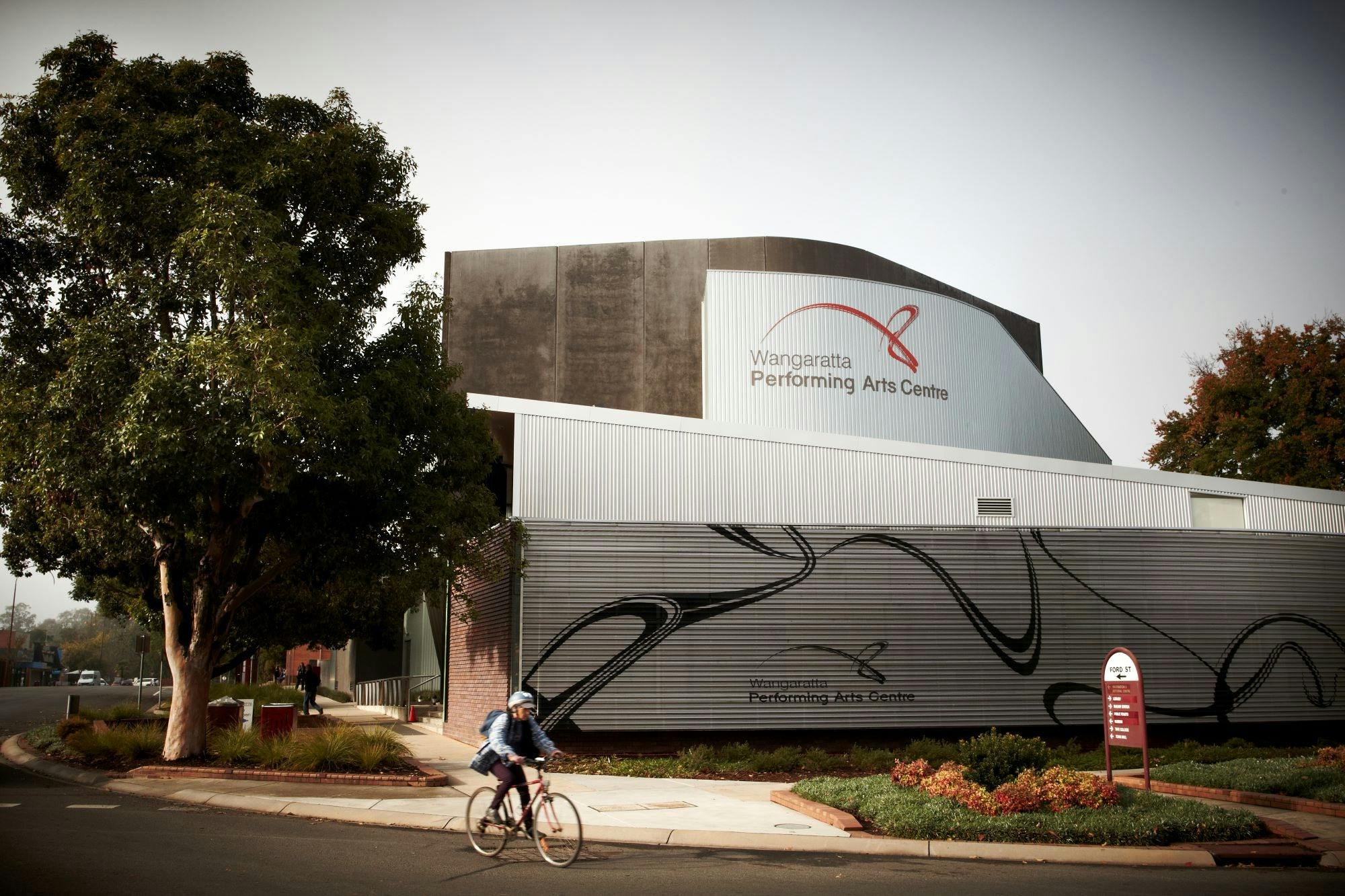 Wangaratta performing arts & convention centre building, tree, road, cyclist
