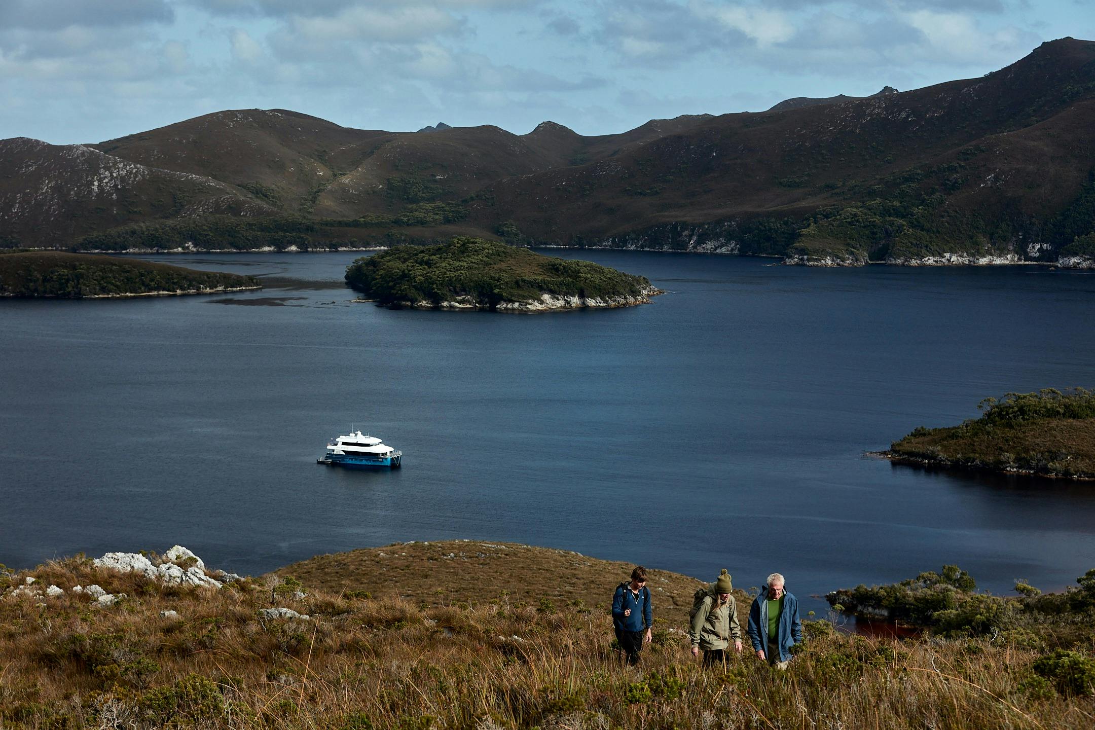 Guests on hike to Mt Stokes, Odalisque III in the entrance to Bathurst Channel. Optional credit Tim