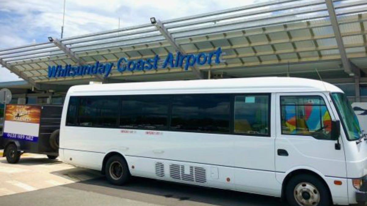 white bus infront of the Whitsunday coast airport