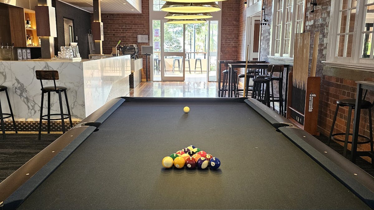 9" American Pool Table with midnight blue felt. 8 Ball pool balls set up ready for a game.