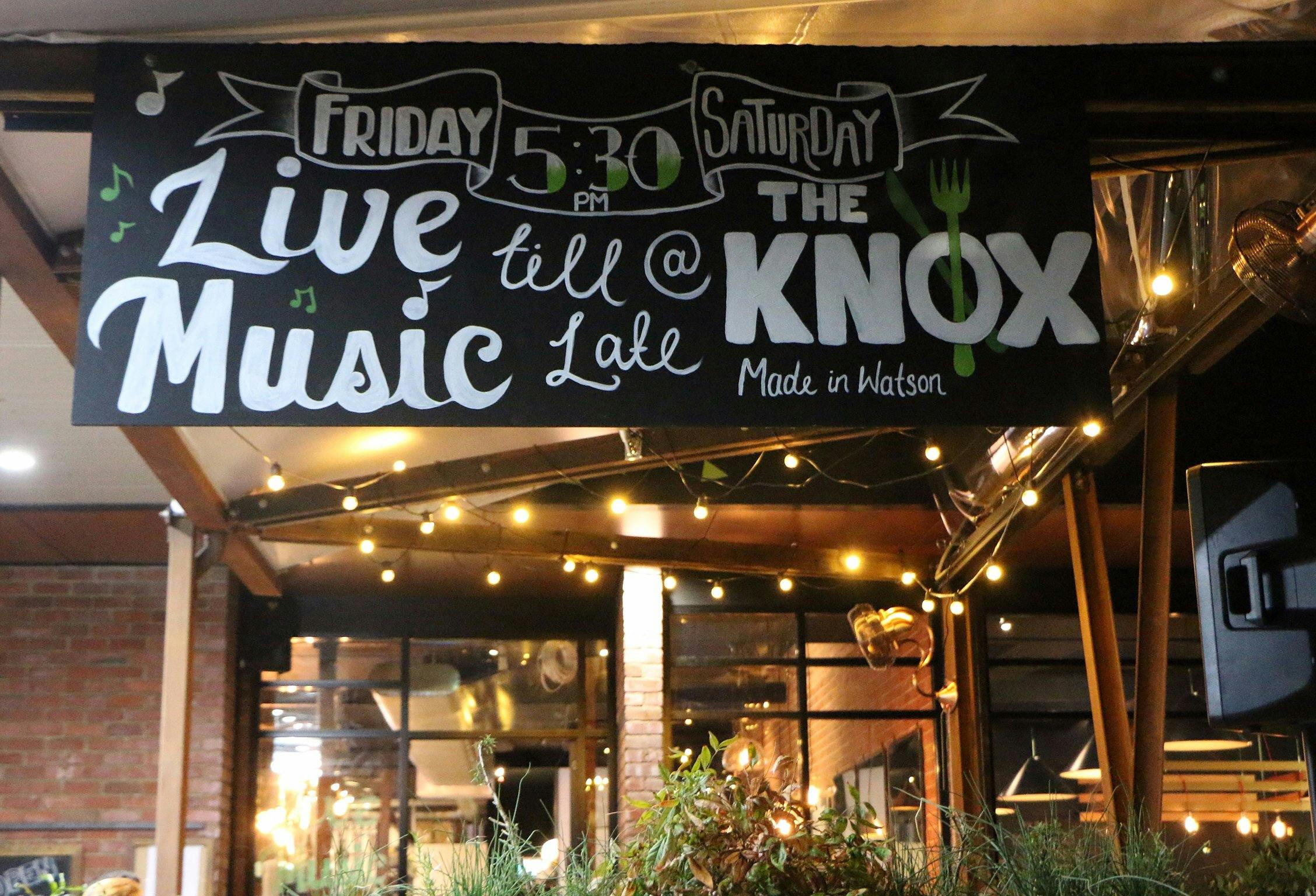 Chalk board sign advertising live music on Friday and Saturday