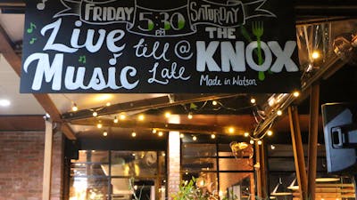 Chalk board sign advertising live music on Friday and Saturday