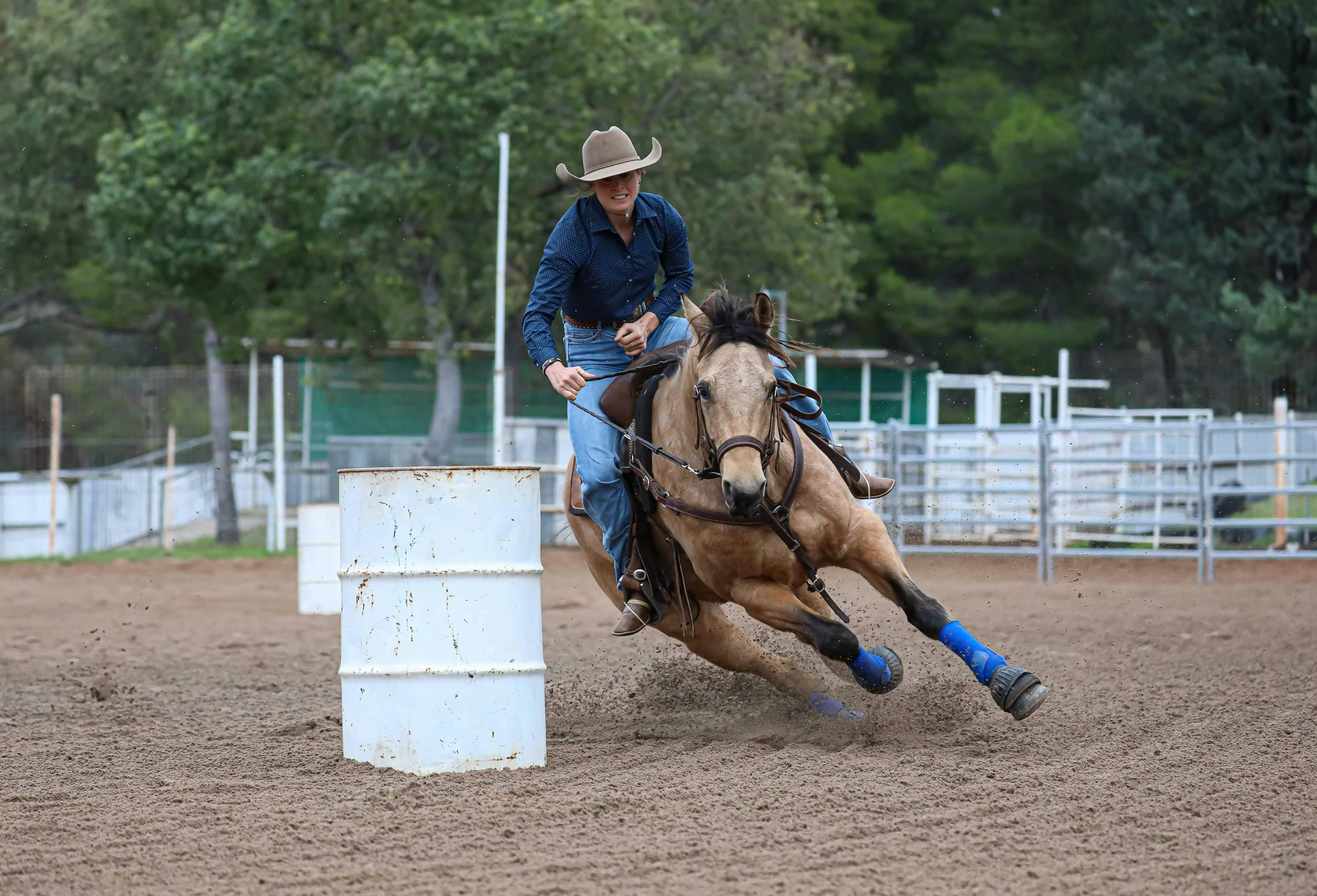 Man on horse racing around barrels