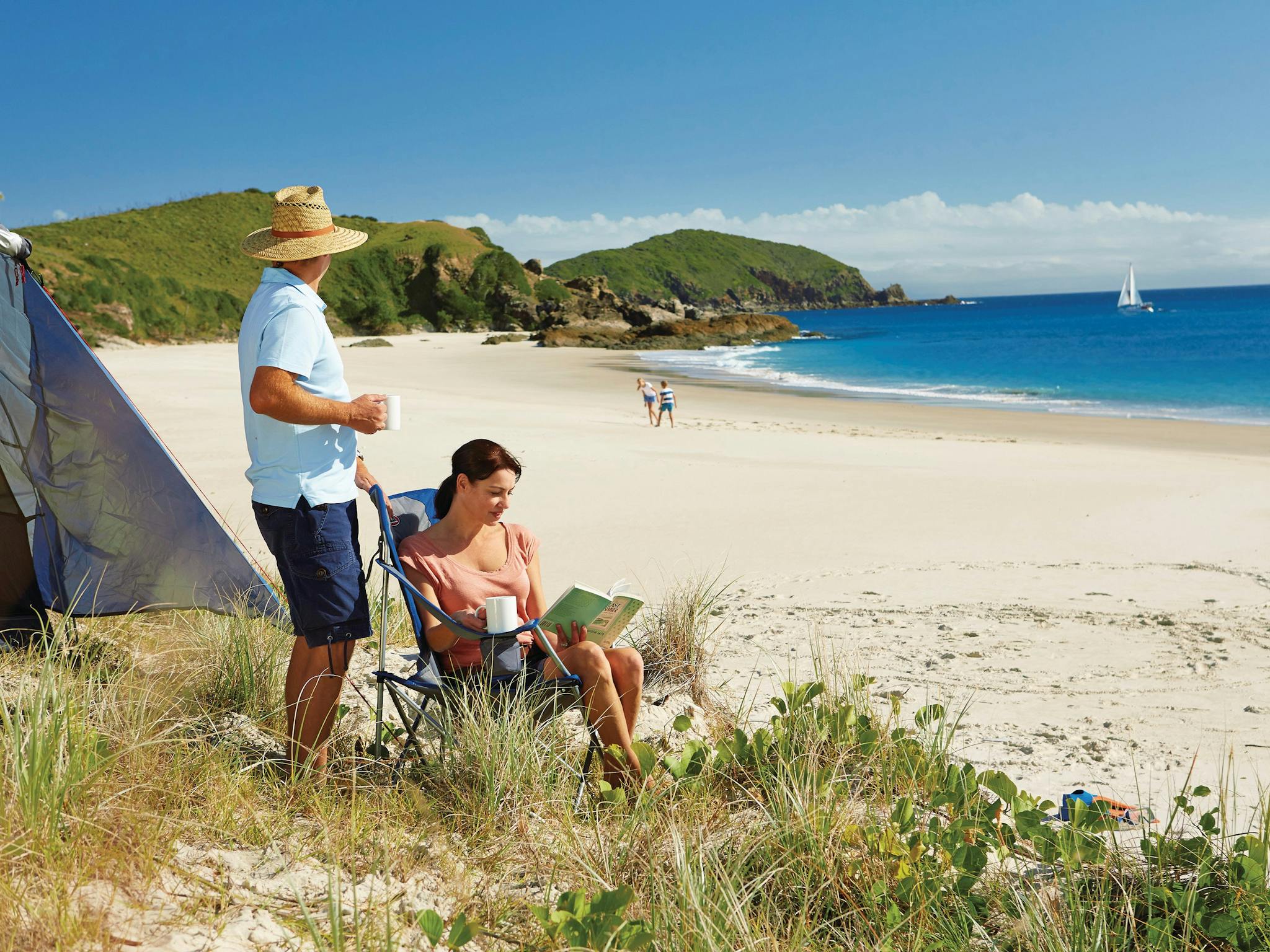 COuple in front of tent near beach in Keppel Islands